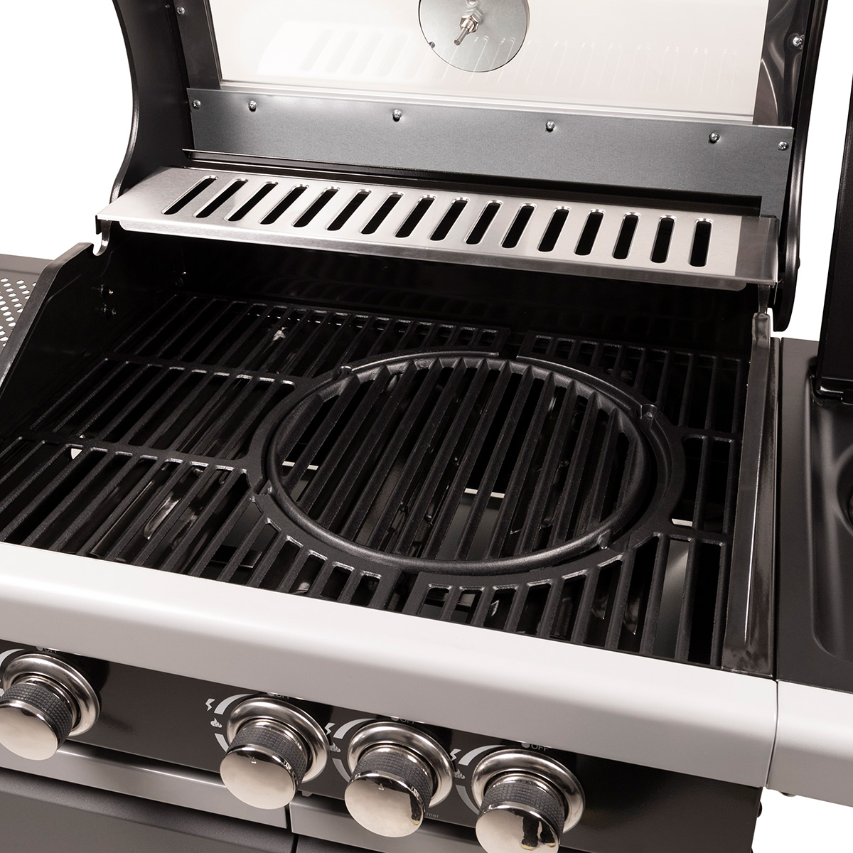 An open outdoor grill showing the grates and a black circular component.
