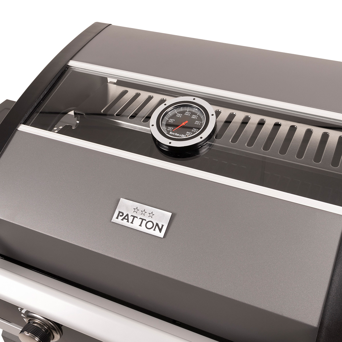 Close-up of a grey and black grill lid with a thermometer and the brand name 'PATTON'.