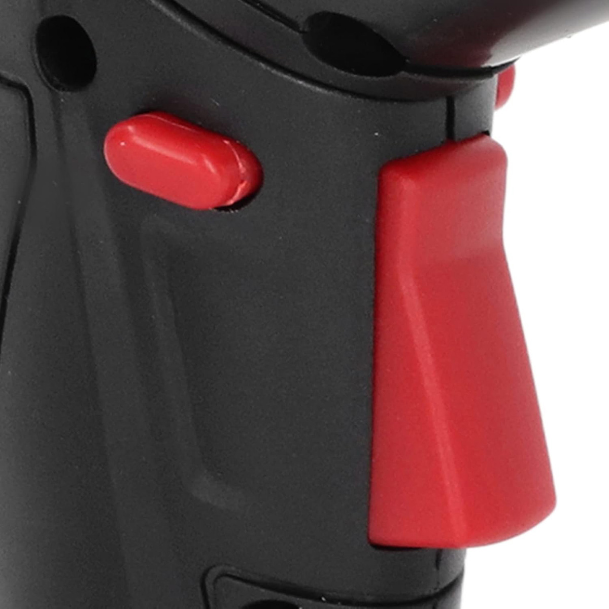 Herramienta negra con botón rojo, primer plano. Cuerpo negro con gatillo rojo.