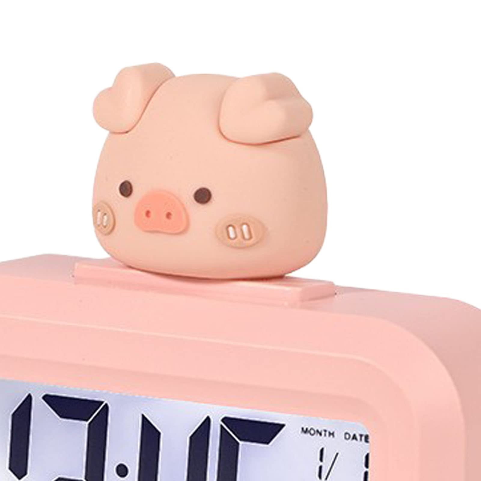 Nahaufnahme eines rosa Weckers mit Schweinchen. Die Anzeige zeigt Zeit und Datum.