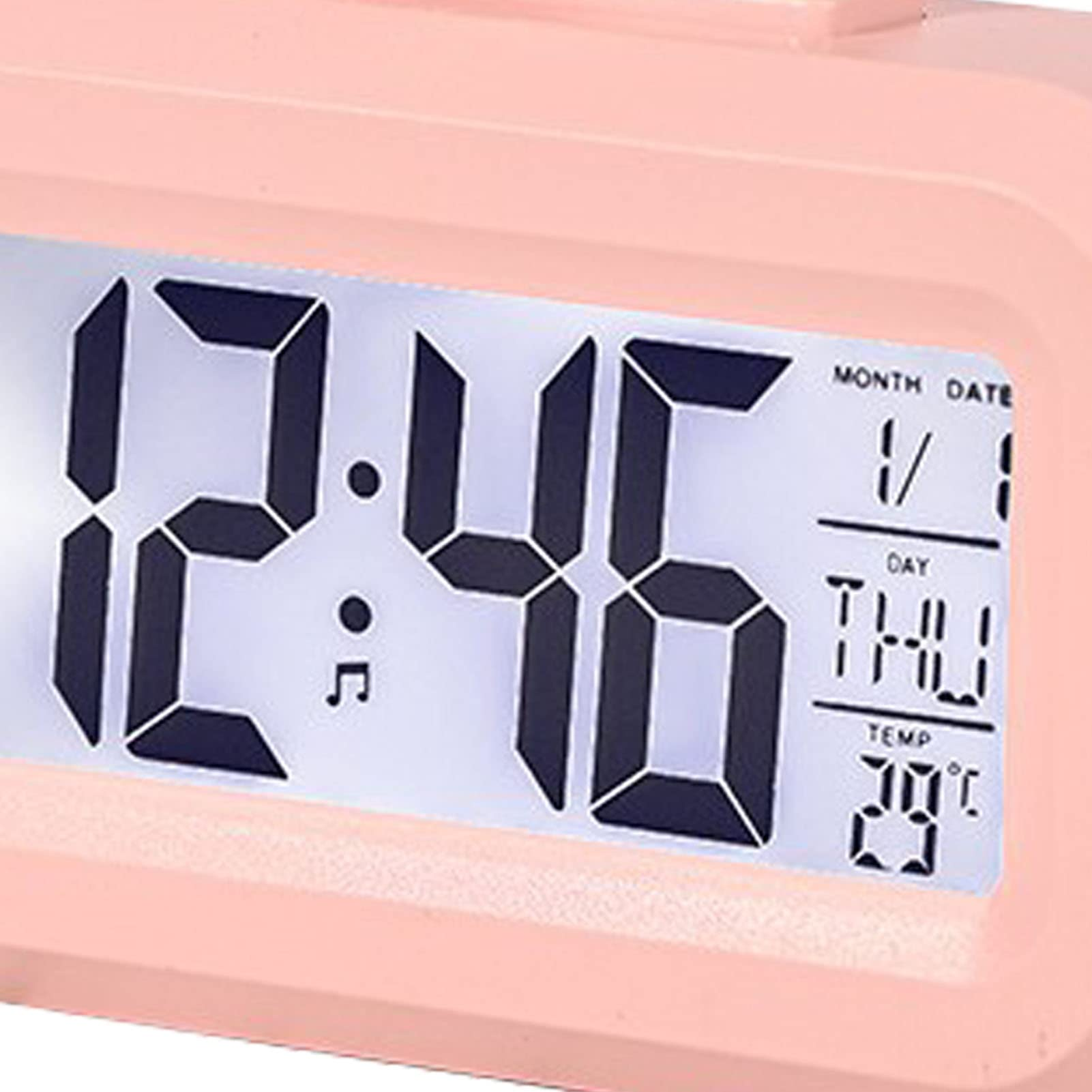 Nahaufnahme eines rosa Weckers. Er zeigt die Uhrzeit und das Datum auf seinem Digitaldisplay.