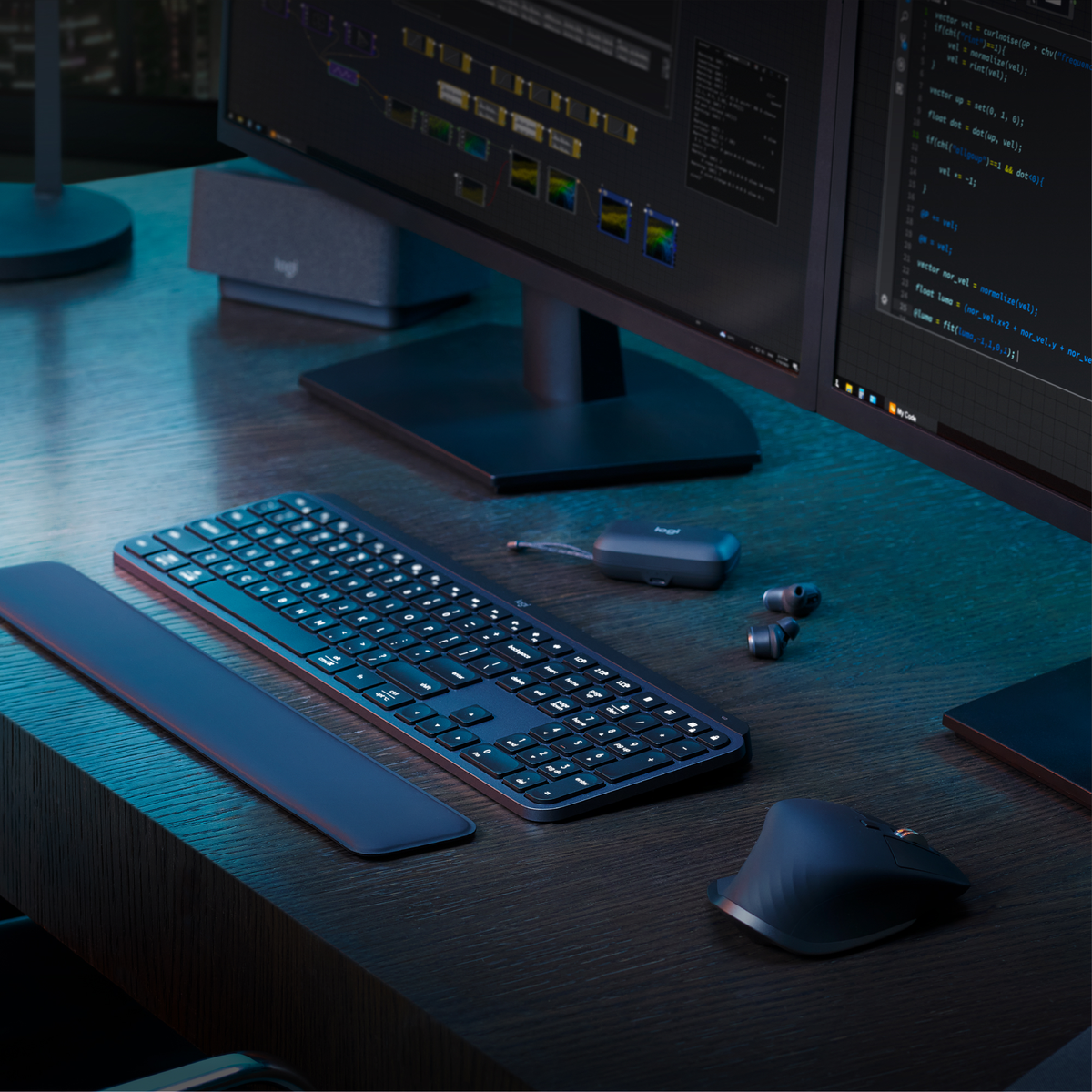 Ciemne biurko z klawiaturą, myszą, monitorami i akcesoriami biurowymi.