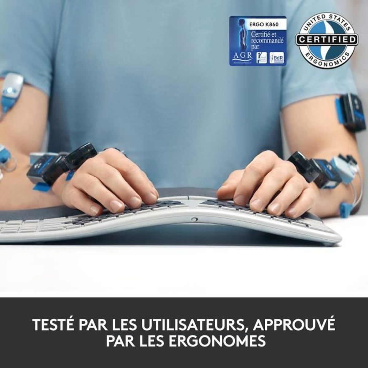 Mani di una persona su una tastiera ergonomica, con sensori sulle braccia. Testo: testato dagli utenti, approvato dagli ergonomisti.