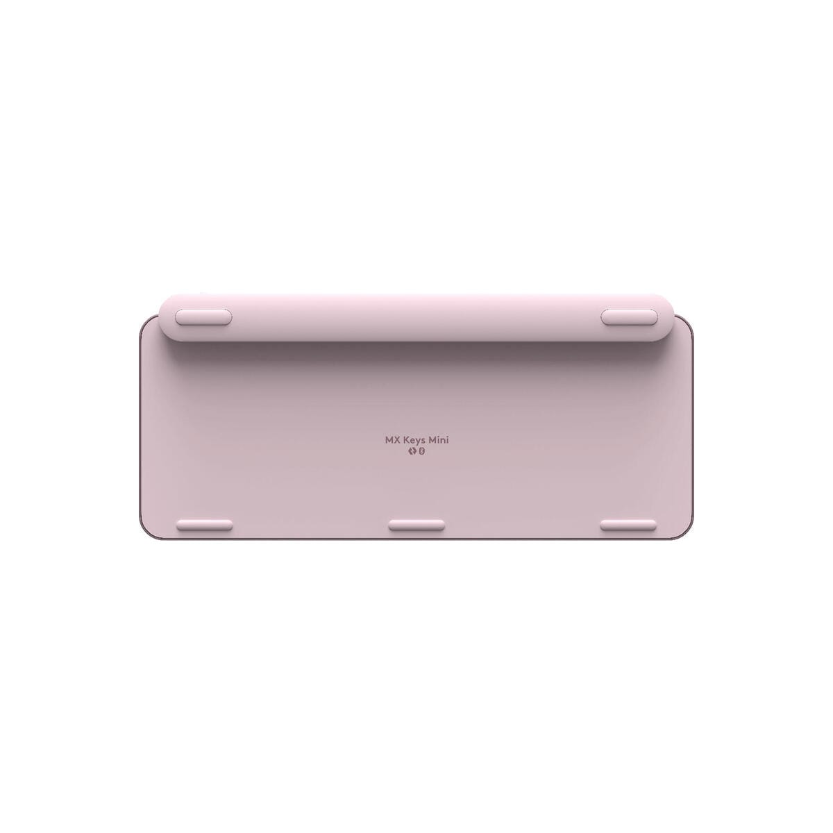 Teclado rosa con parte posterior plana y cuatro patas de goma.