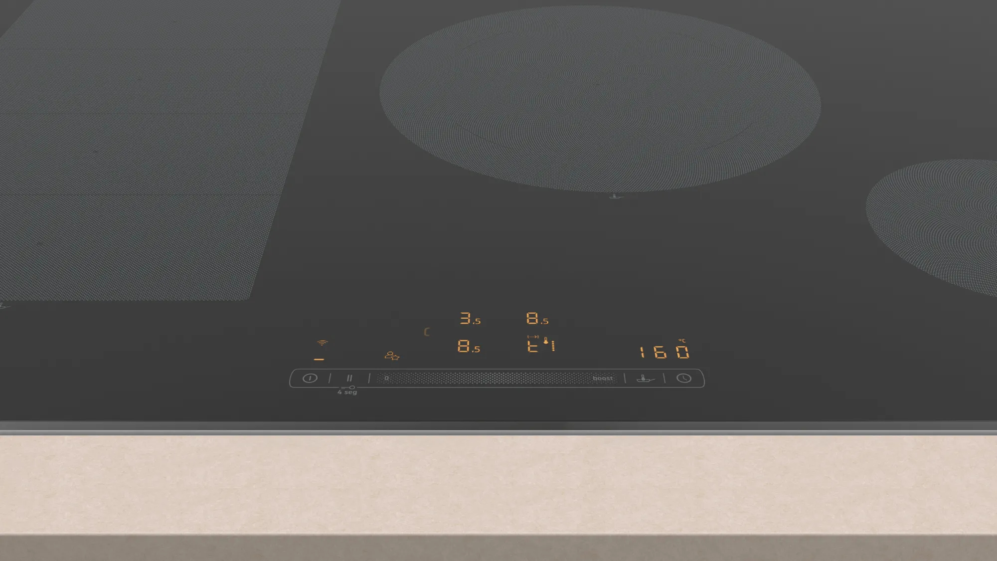 Zbliżenie czarnej płyty grzewczej z okrągłymi elementami grzewczymi i wyświetlaczem.