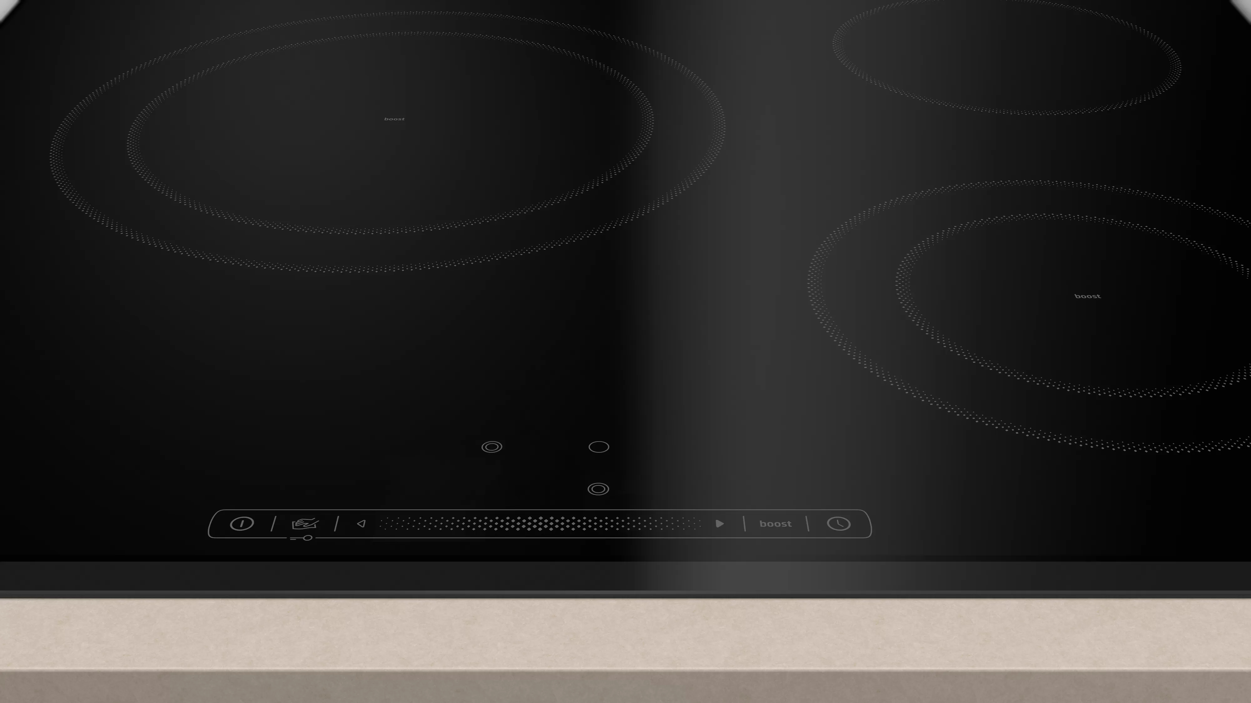 Czarna płyta indukcyjna z czterema okrągłymi strefami gotowania i panelem sterowania na beżowym blacie.