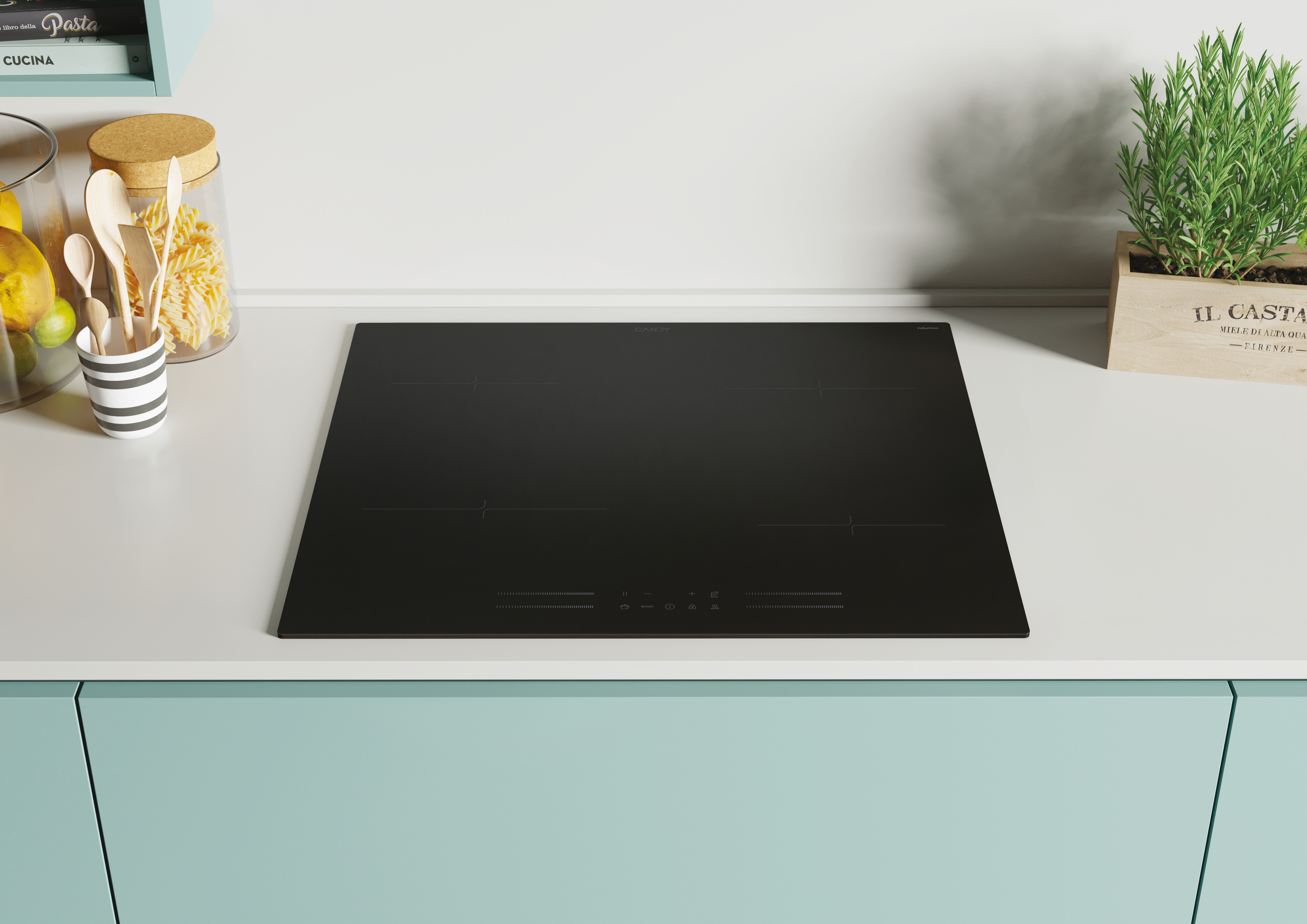 Czarna płyta indukcyjna na białym blacie w kuchni.