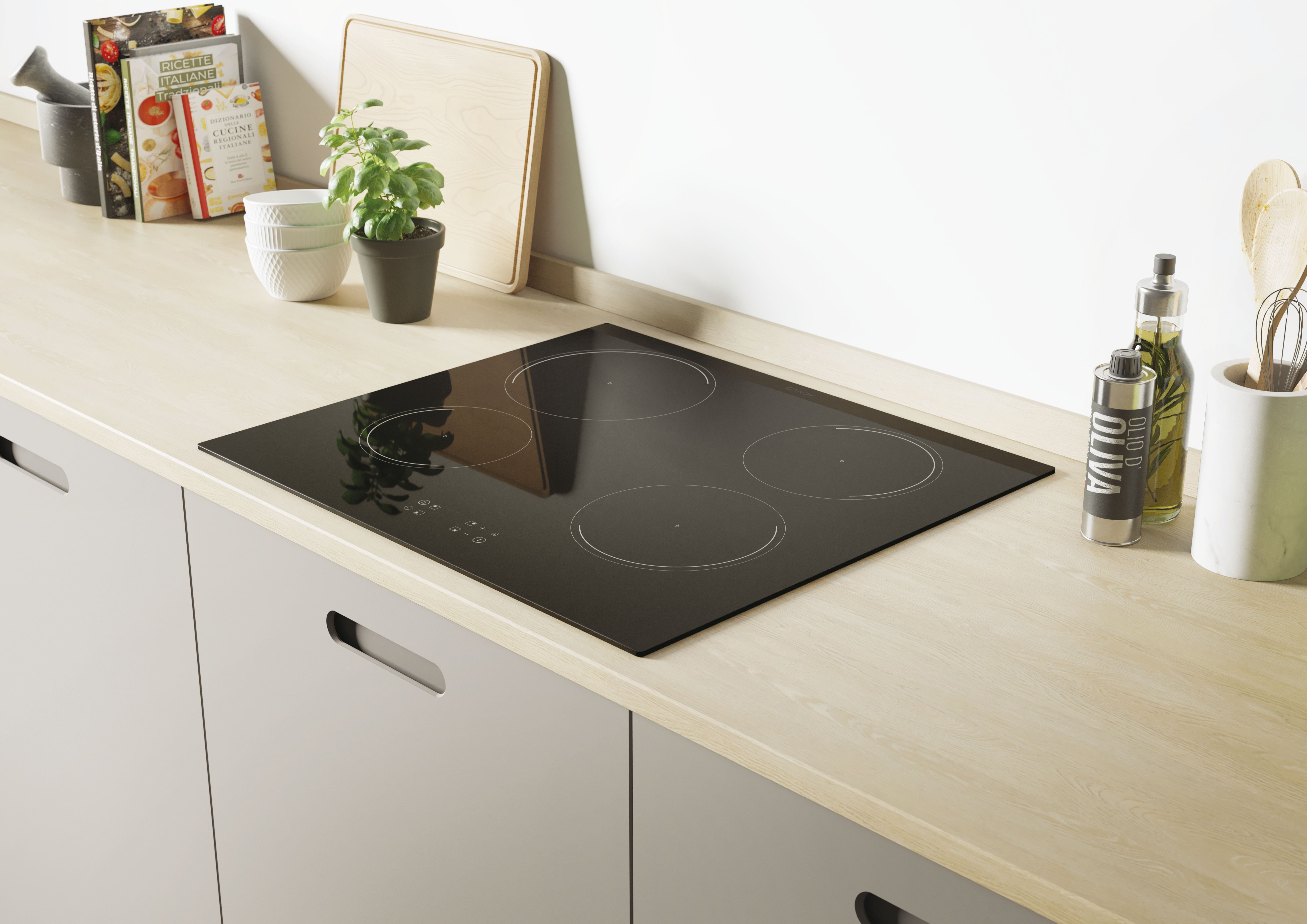 Un piano cottura a induzione nero con quattro fuochi circolari su un piano di lavoro in legno.