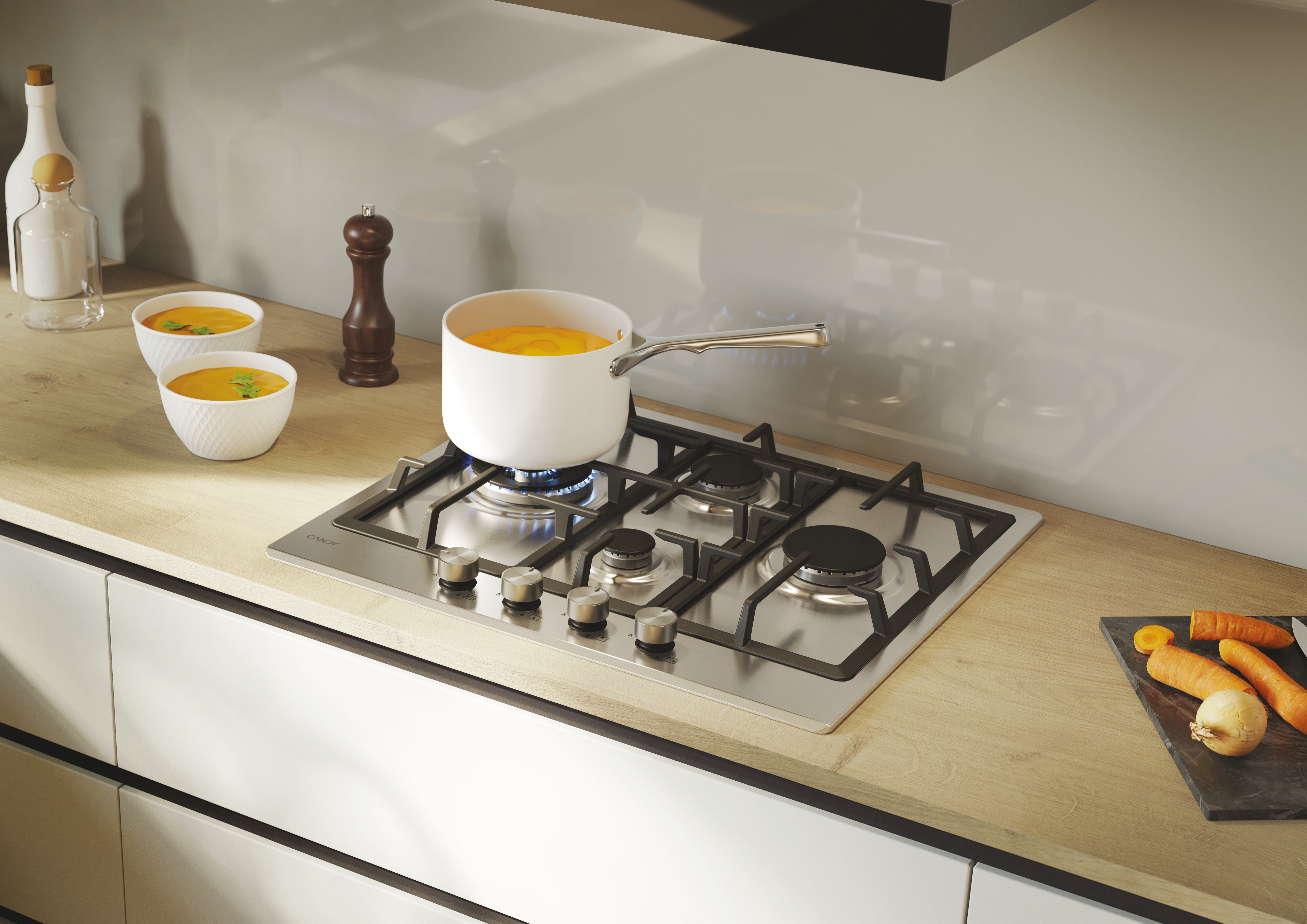 Scena kuchenna z płytą grzejną. Zupa gotuje się w garnku, a obok miski.