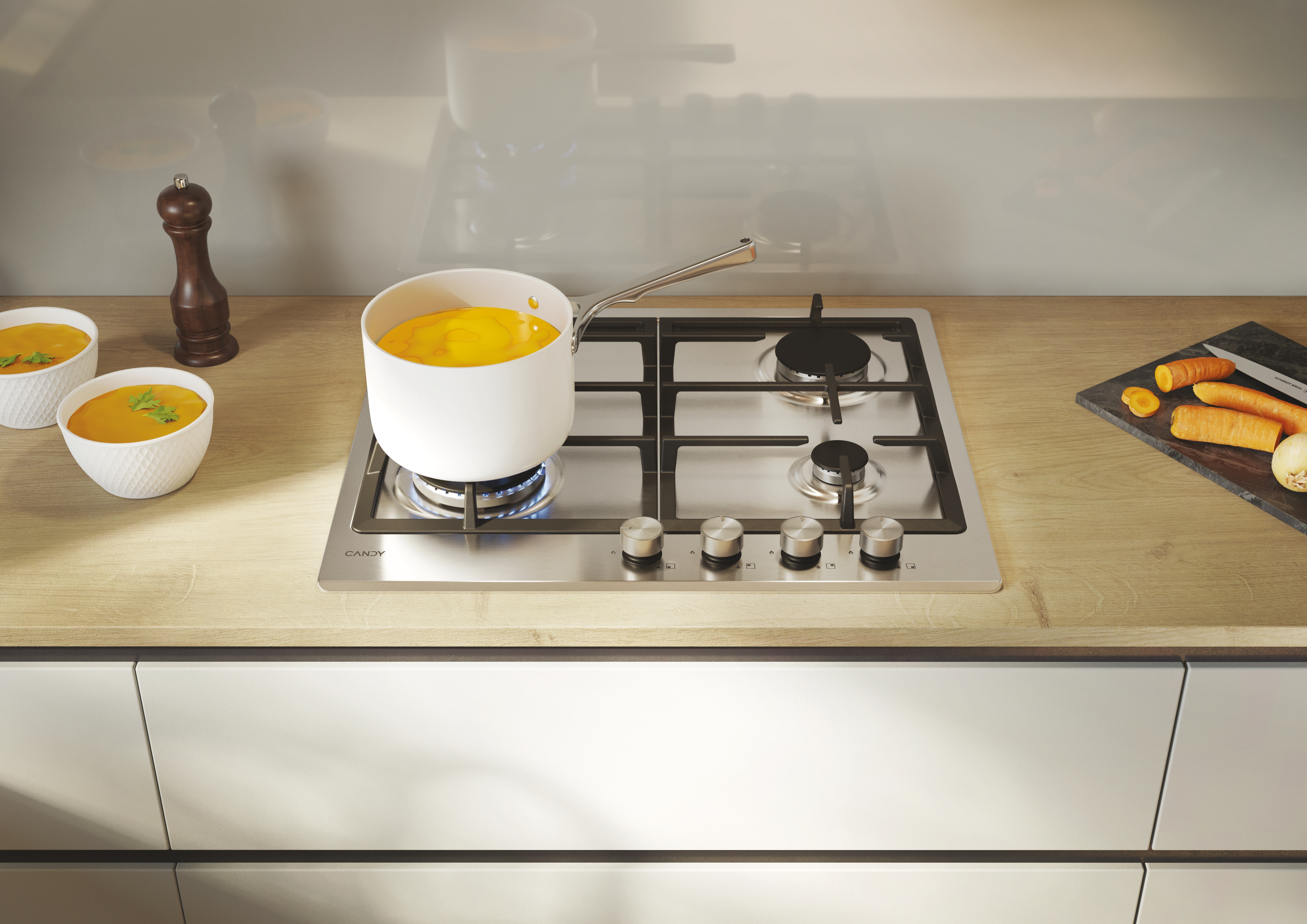 Scena kuchenna z gotowaniem, biały garnek na płycie, dwie miski z zupą i drewniany stół.