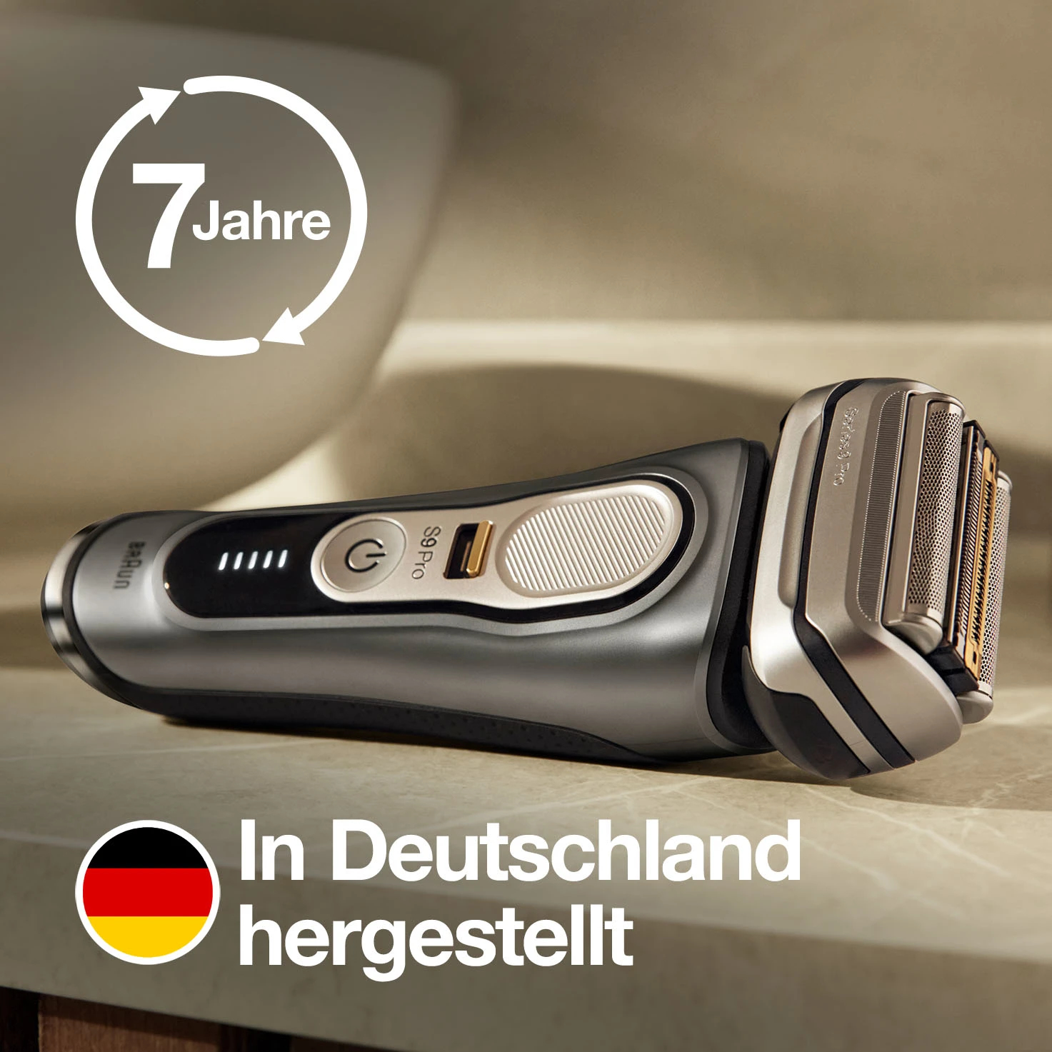 Srebrno-czarna golarka elektryczna z białym okręgiem i niemieckim tekstem.