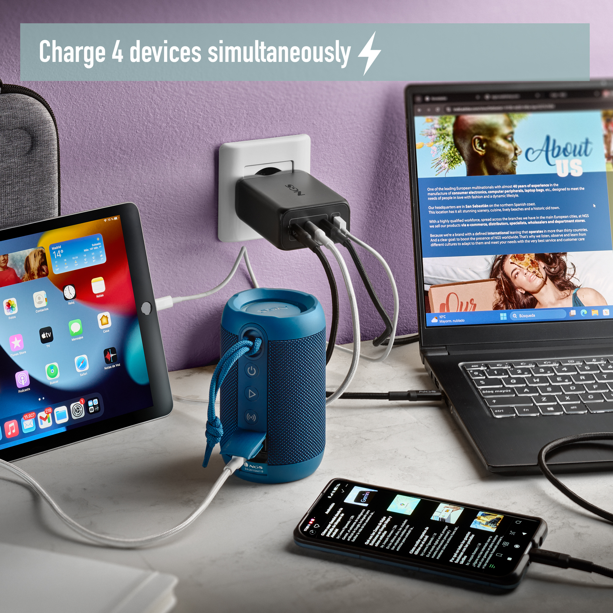 Una stazione di ricarica con più dispositivi collegati, vicino a un laptop.