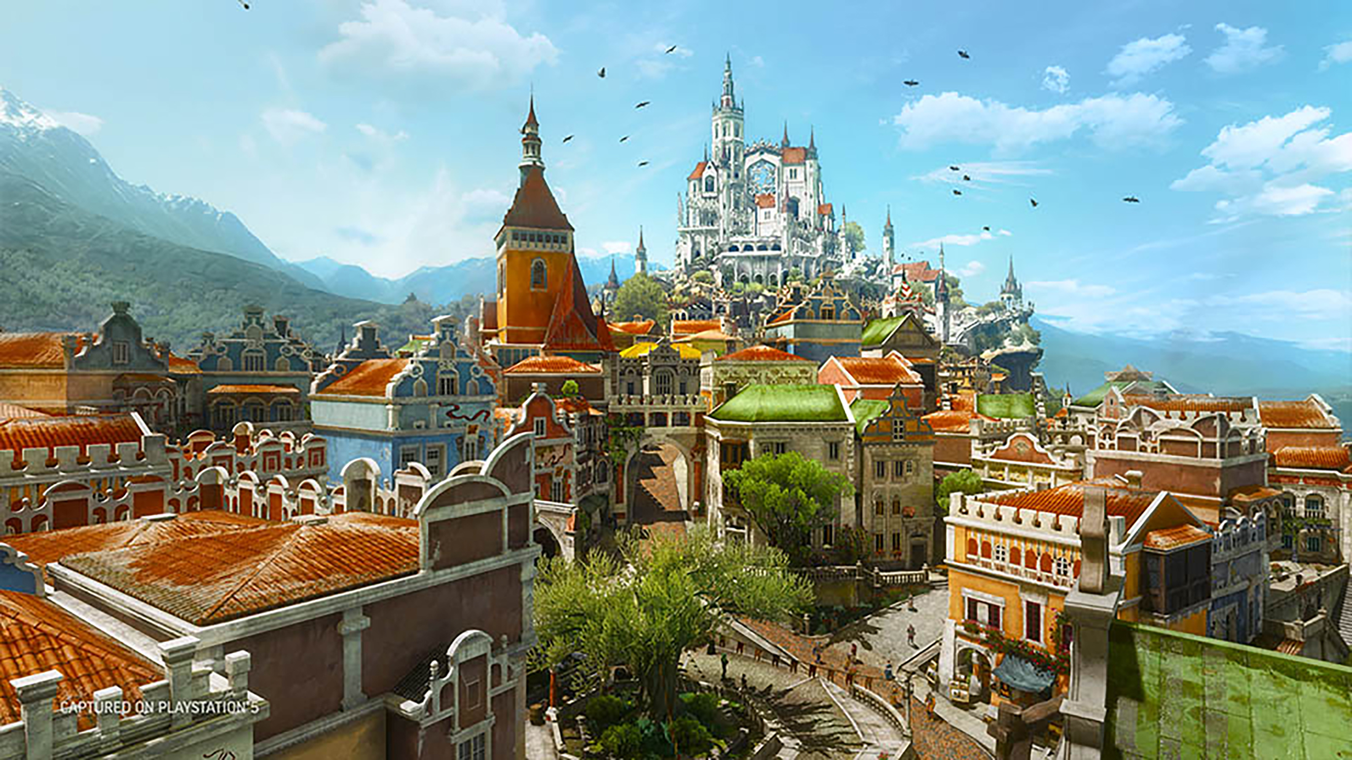 Pejzaż miejski z The Witcher 3: Wild Hunt. Kolorowe budynki, góry w tle, czyste błękitne niebo.