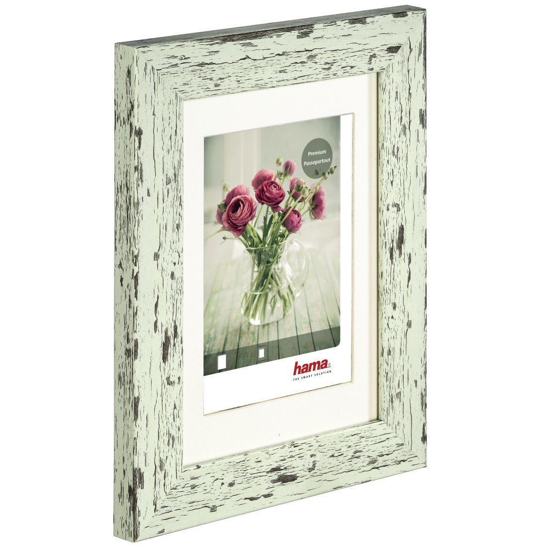Ein grüner, verwitterter Bilderrahmen, der ein Bild von Blumen in einer Vase enthält.