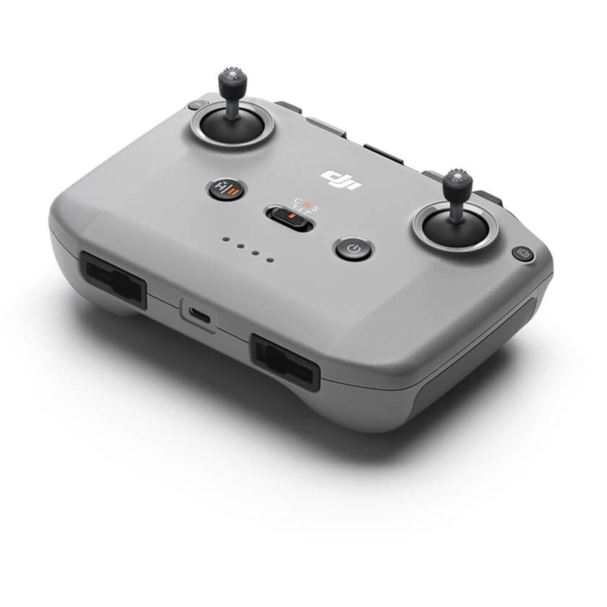 Szary kontroler drona, widok z góry, z przyciskami i joystickami, na białym tle.