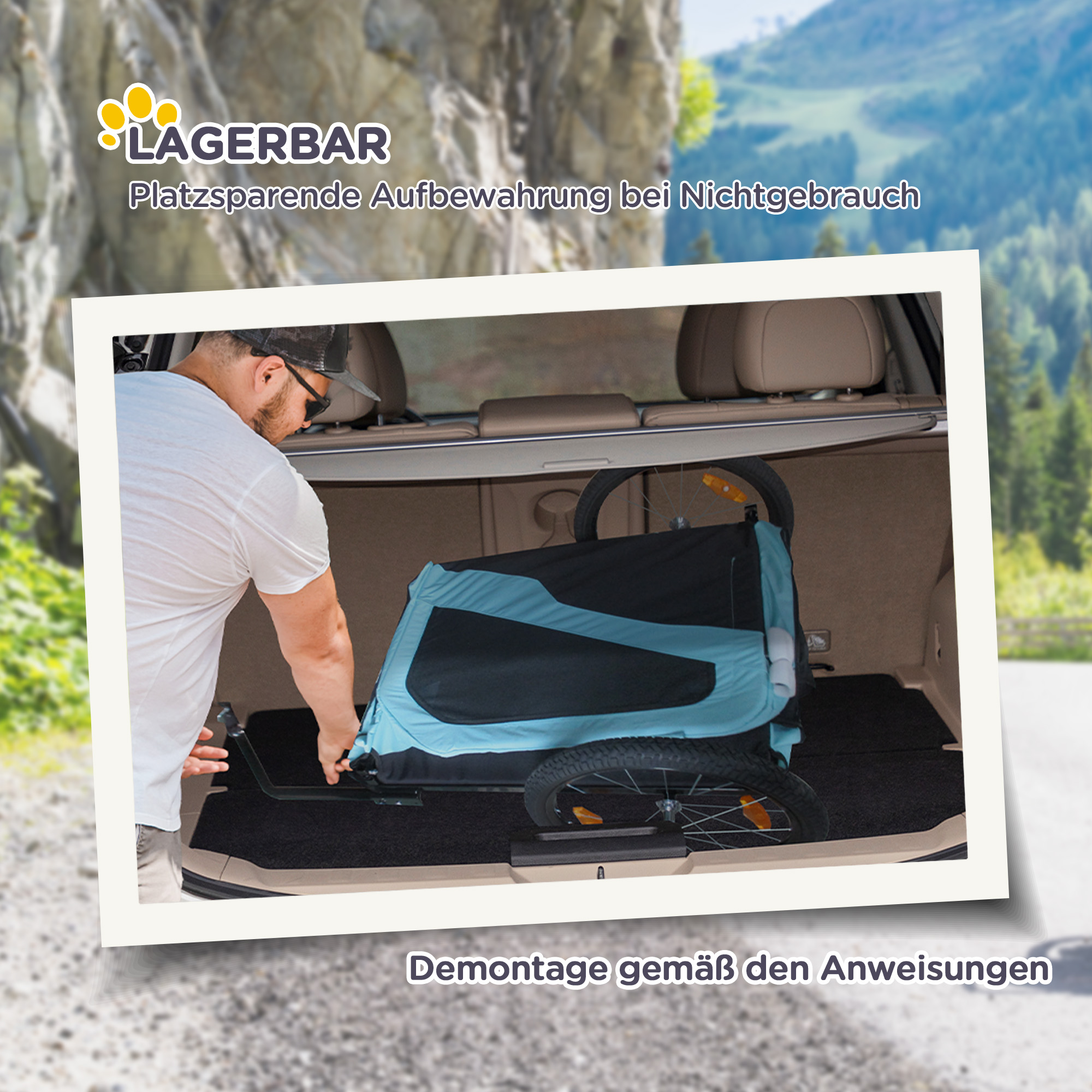 Ein Mann lädt einen blau-schwarzen Anhänger in ein Auto. Der Hintergrund zeigt eine Berglandschaft.