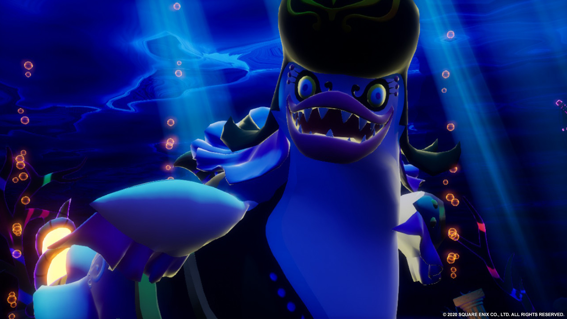 Niebiesko-fioletowa stwór przypominający potwora z ostrymi zębami i kapeluszem. Stwór znajduje się w podwodnej scenerii.