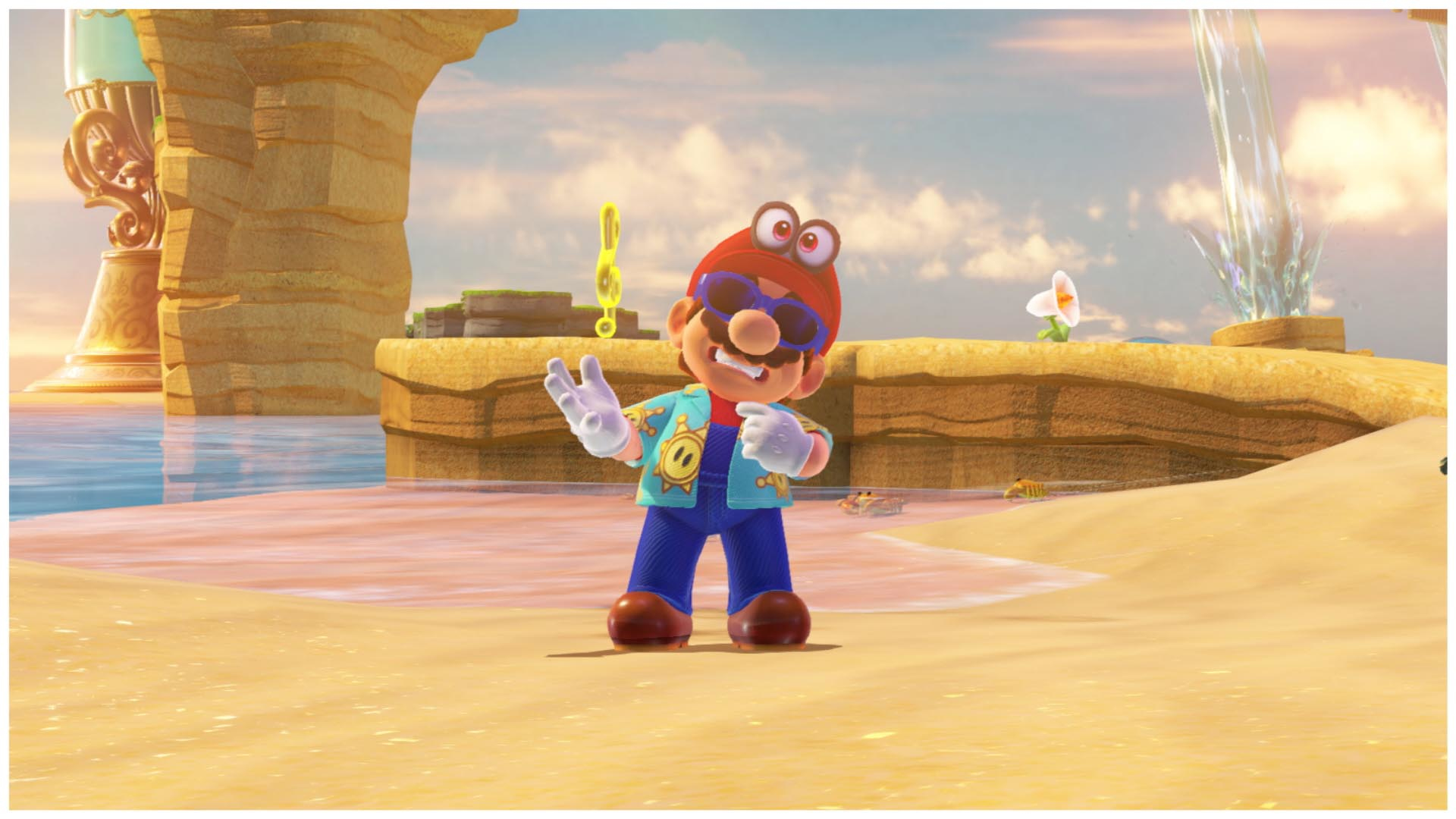 Mario su una spiaggia, che saluta, con occhiali da sole e camicia tropicale.