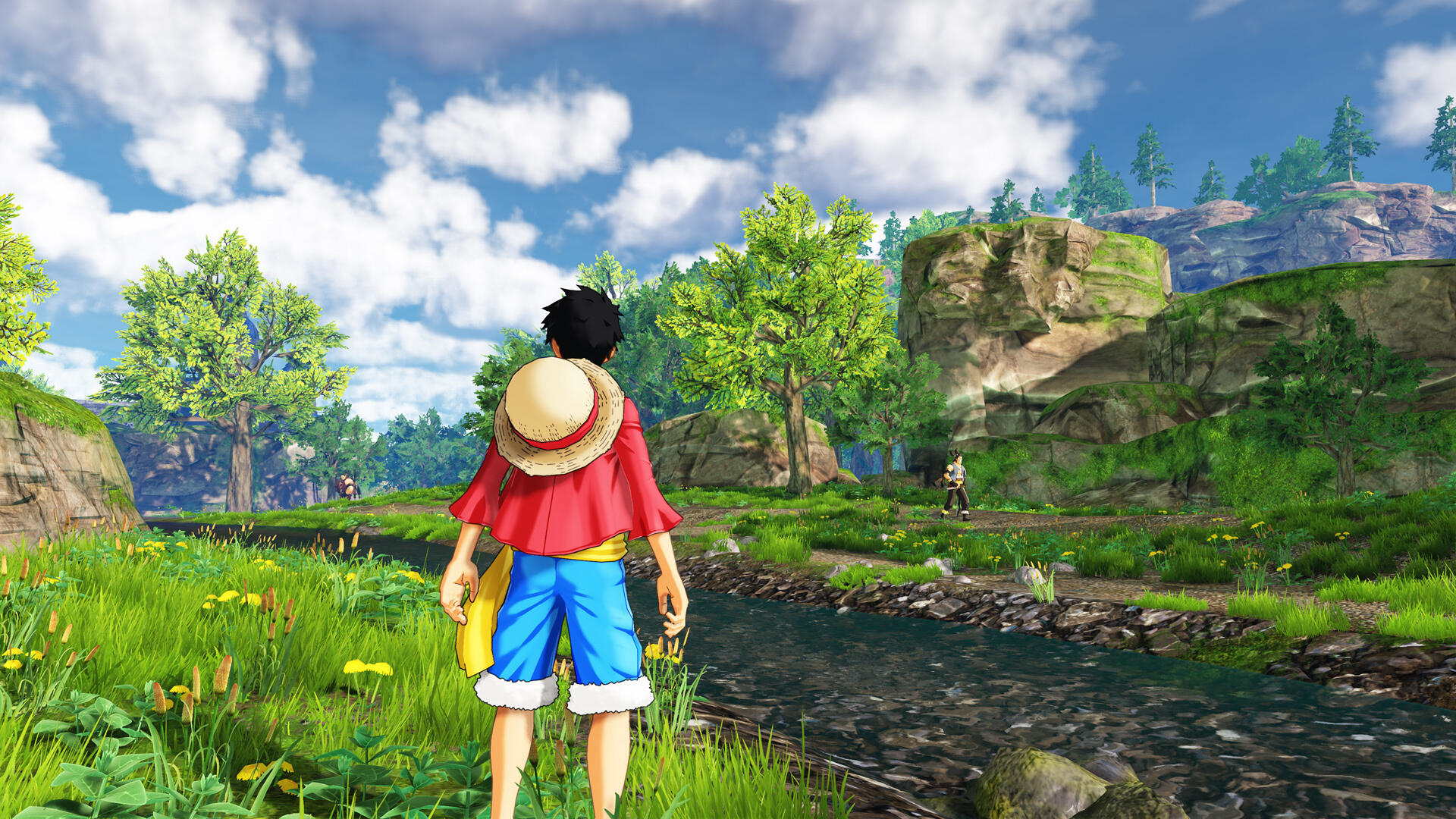 Luffy uit One Piece, in een grasveld bij een rivier, met bergen op de achtergrond.