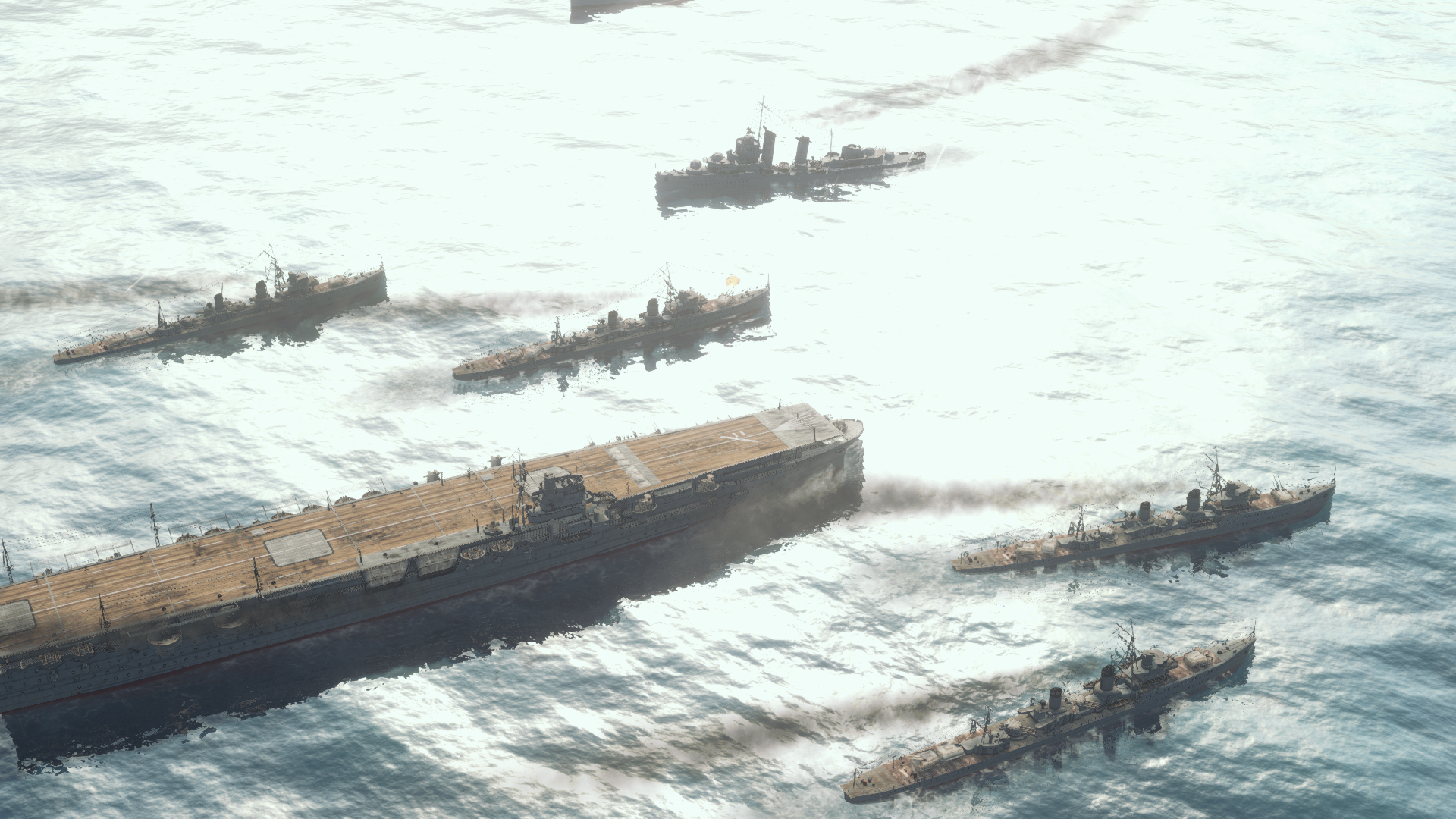 Flota okrętów wojennych płynie po morzu. Lotniskowiec znajduje się w centrum, otoczony przez inne statki.