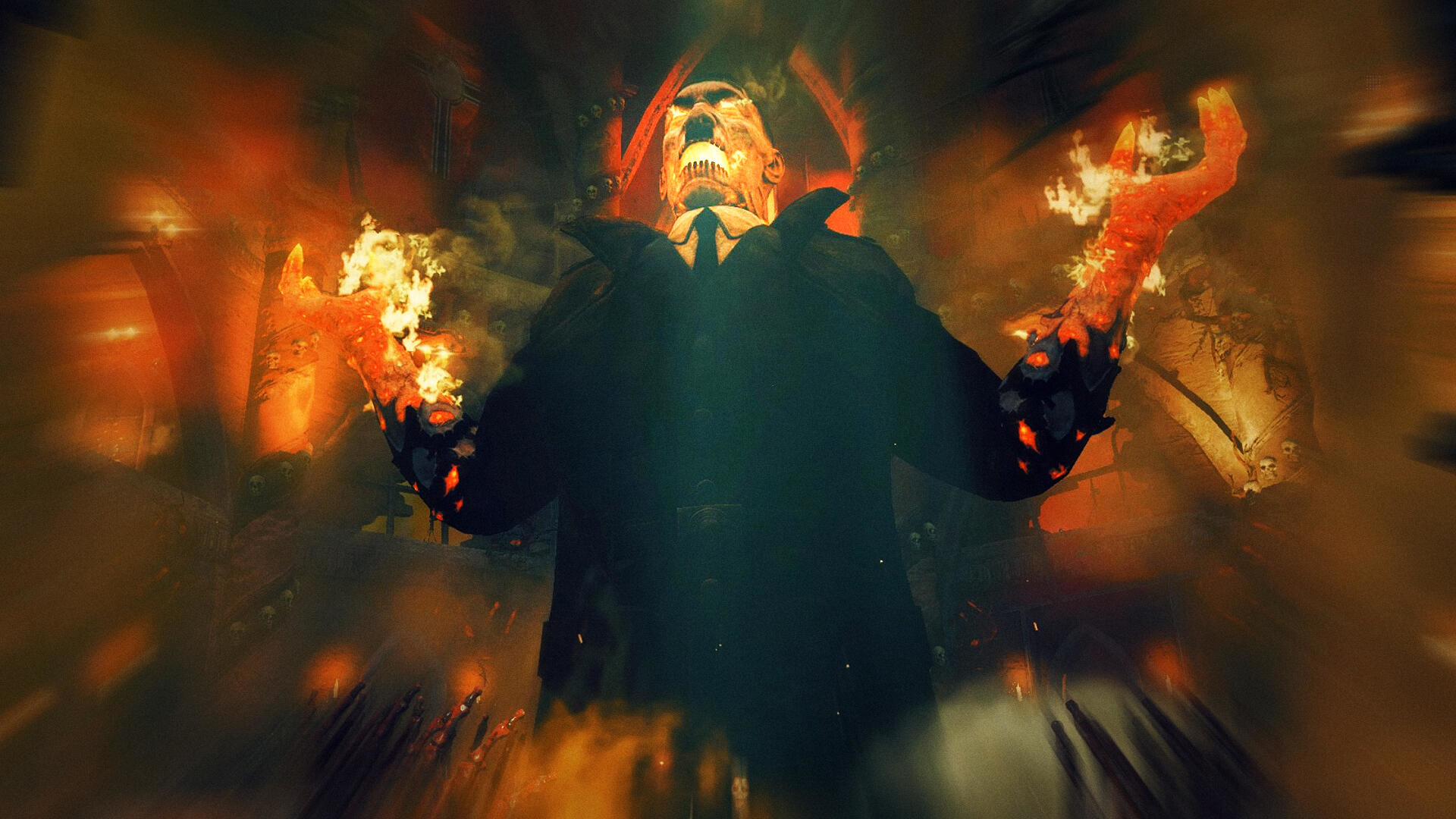 Postać z płonącymi dłońmi stoi w ognistym otoczeniu. Tło jest rozmyte.