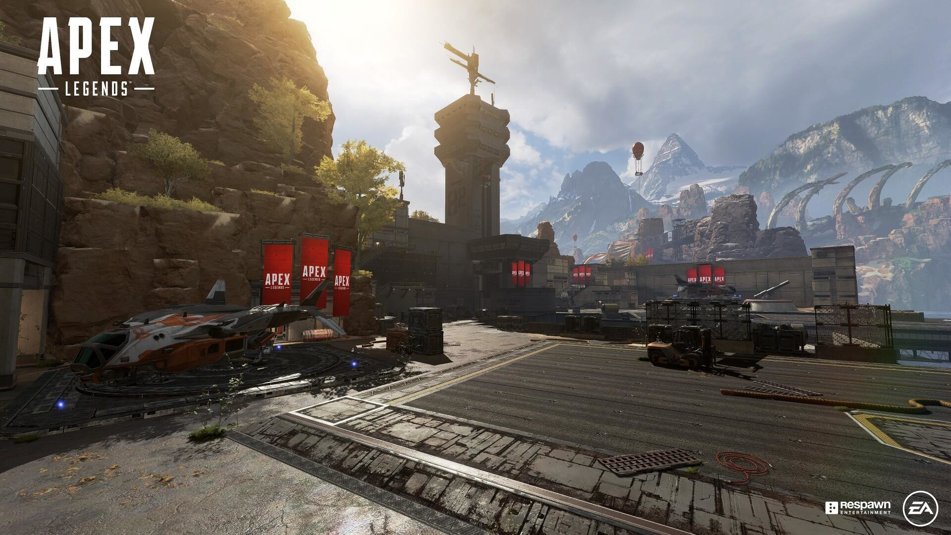 Górzysty krajobraz z instalacją wojskową i czerwoną flagą z napisem Apex Legends.