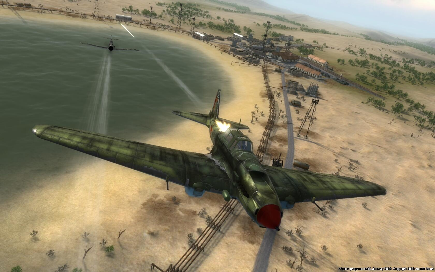 Samolot leci nad plażą, z dwoma walczącymi samolotami. Budynki i drzewa w tle.