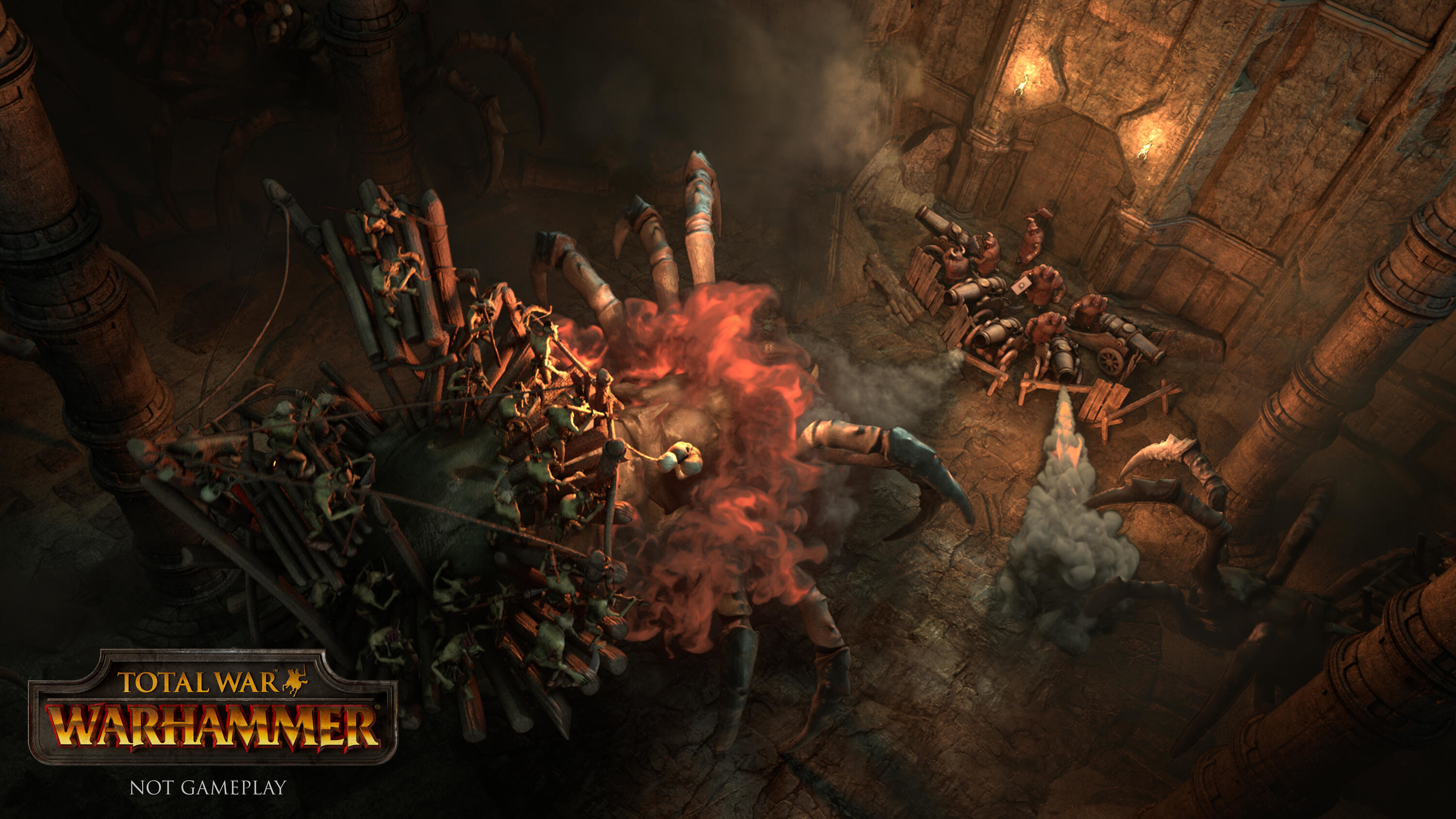 Total War Warhammer Szene mit riesiger Spinne und kleinen Figuren. Szene in dunkler Höhle.