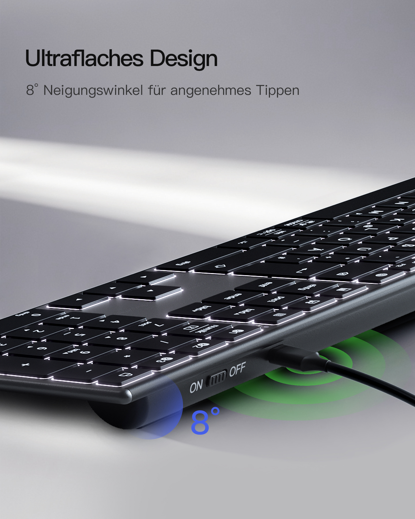 Eine schwarze Tastatur mit weißen Tasten, ein Ladekabel und ein grünes Licht mit den Wörtern ON und OFF.