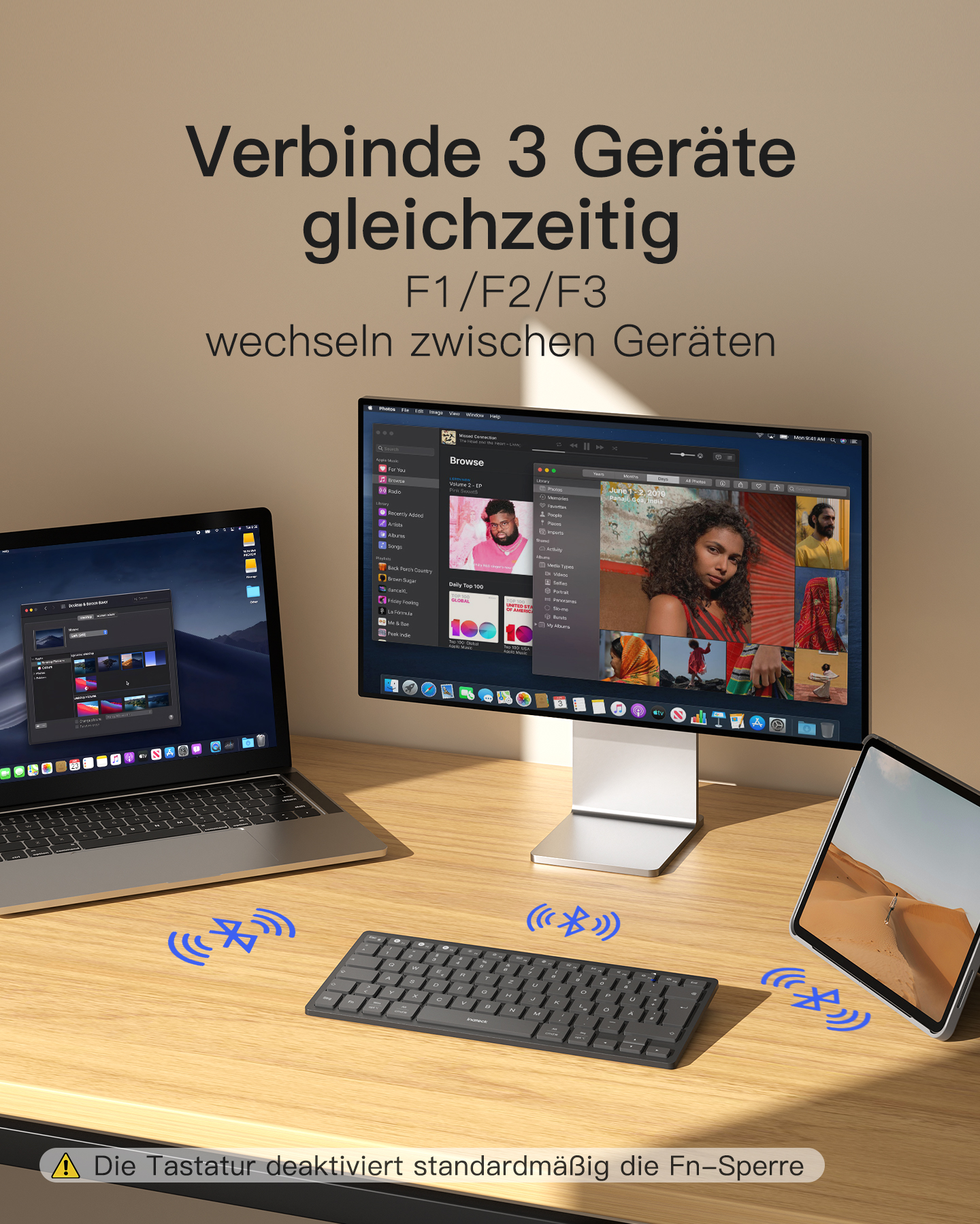Laptop, Monitor, Tastatur und Tablet auf dem Schreibtisch, verbunden über Bluetooth.