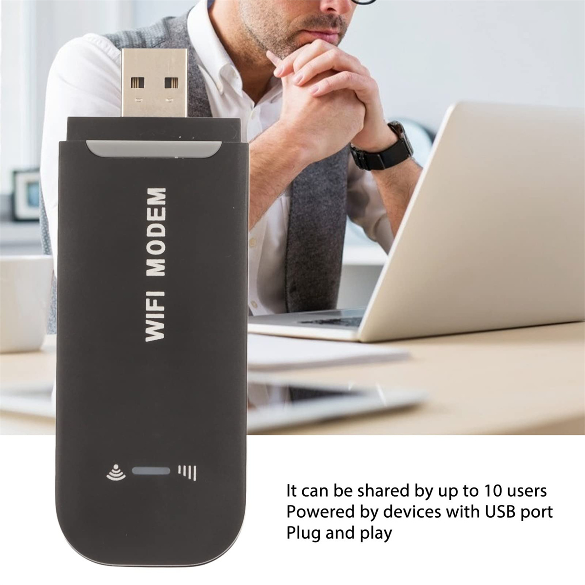 Ein schwarzes WLAN-Modem mit USB-Anschluss und eine Person mit einem Laptop im Hintergrund.