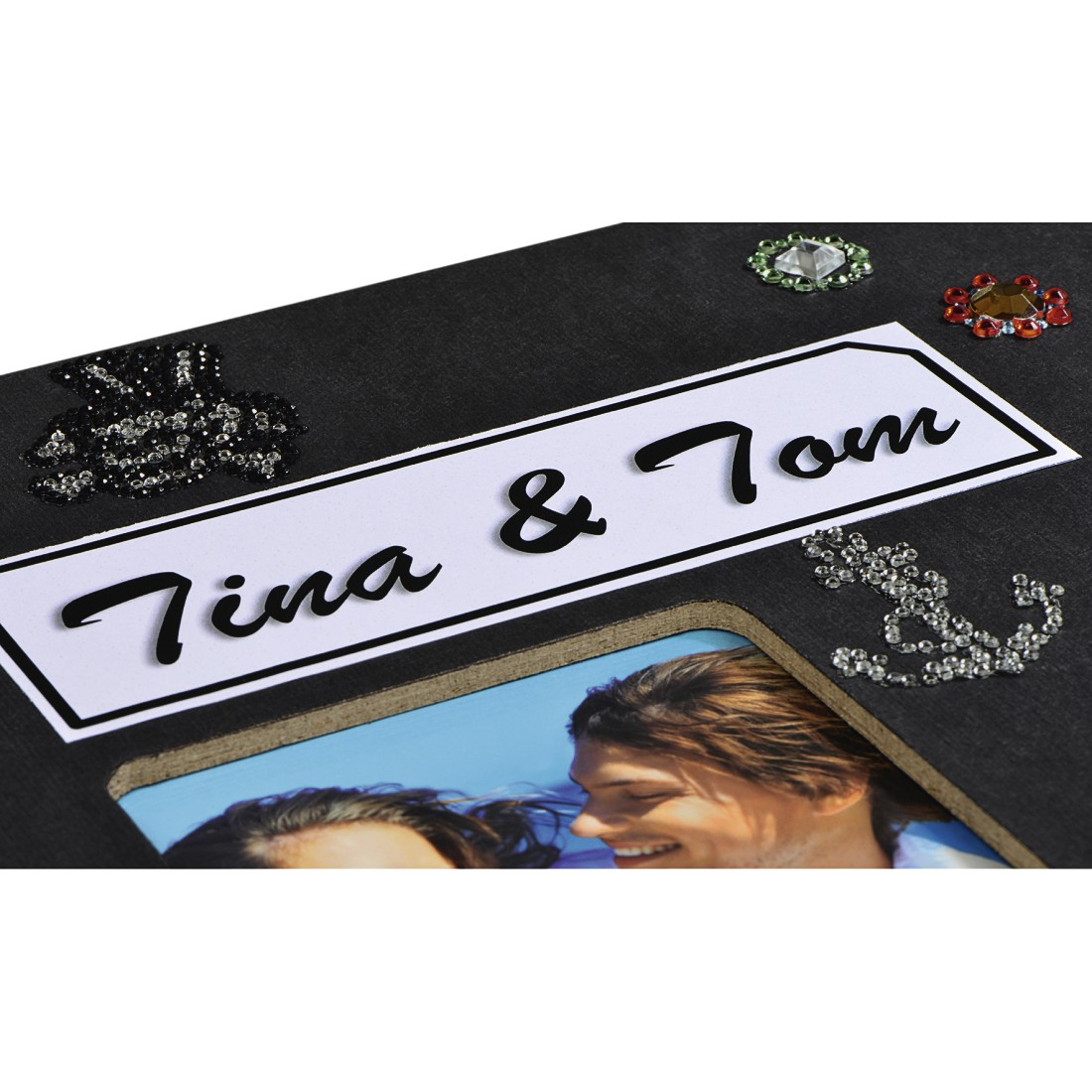 Czarny album ze zdjęciem pary, imionami Tina & Tom i ozdobnymi kamieniami.