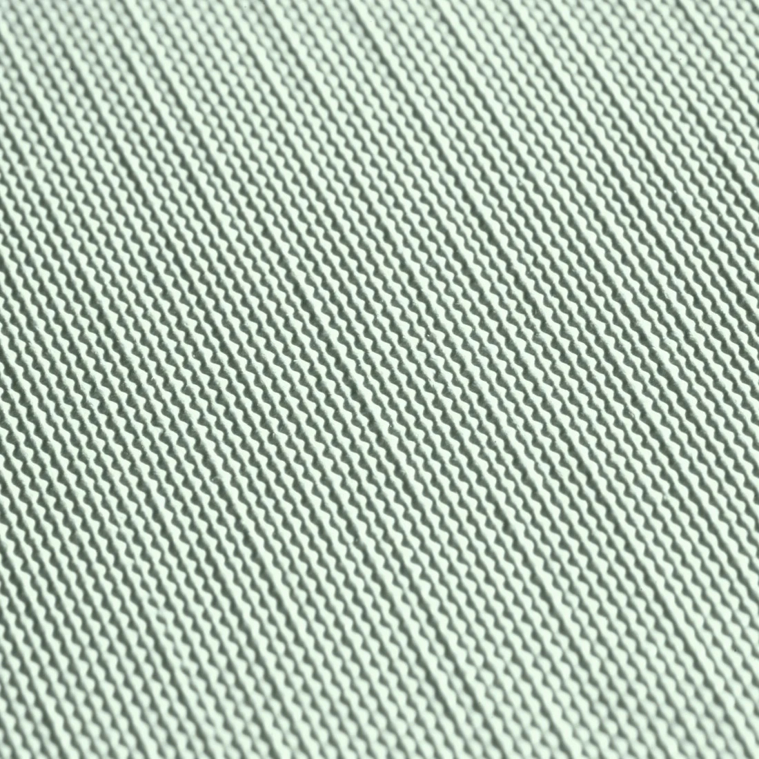 Eine strukturierte Oberfläche mit parallelen diagonalen Linien. Hellgrüne Farbe.