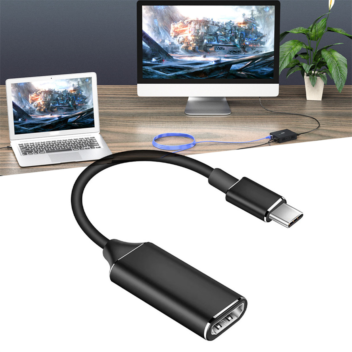 Ein schwarzes USB-C-zu-USB-Adapterkabel, das einen Laptop mit einem Monitor auf einem Holzschreibtisch verbindet.