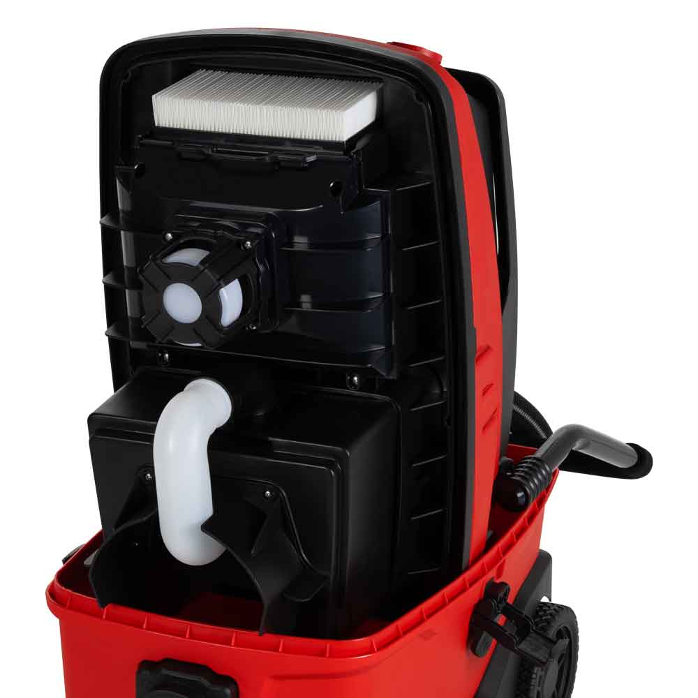 Interno di aspirapolvere rosso e nero, con filtro e tubi visibili.