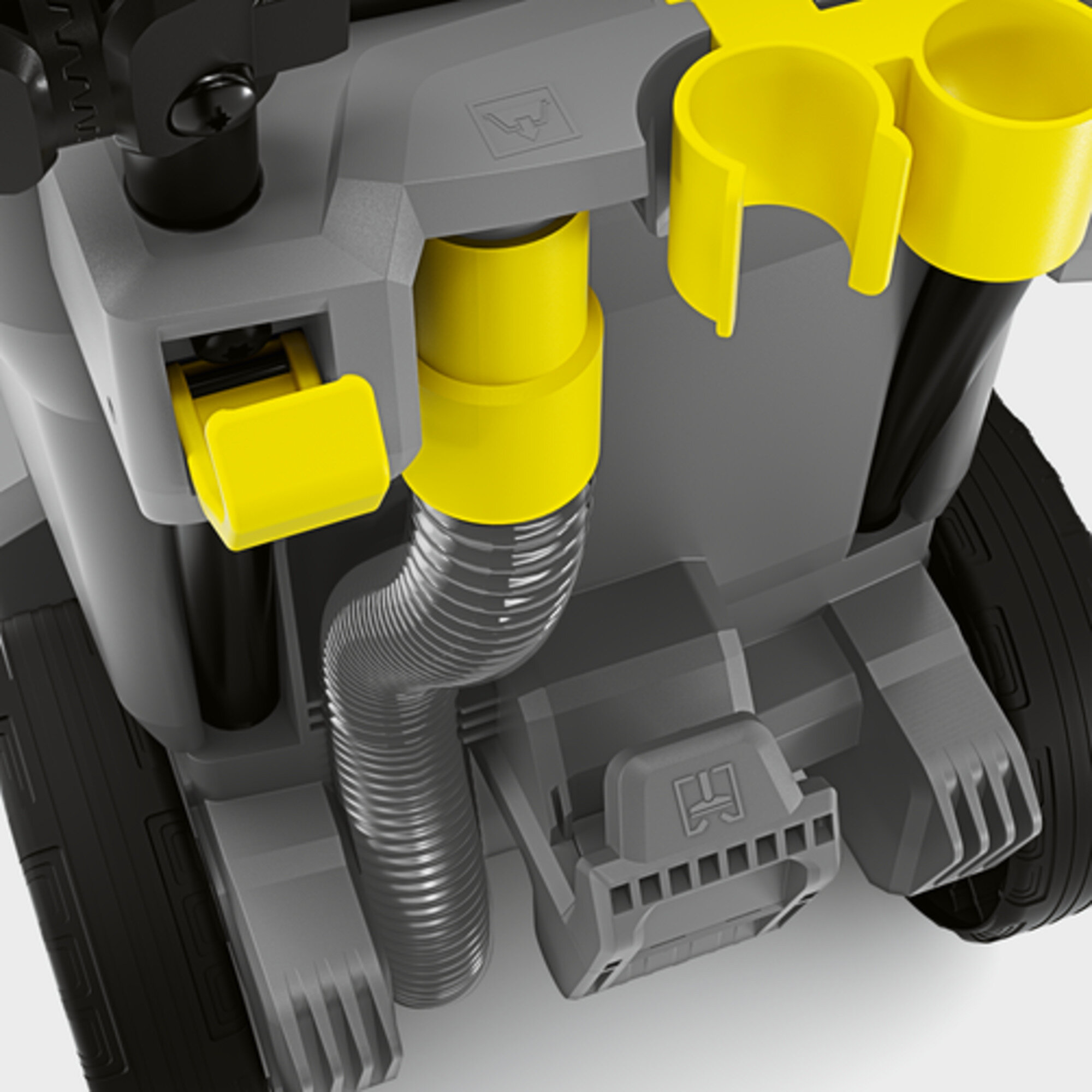 Close-up of a gray and yellow vacuum cleaner's hose connection and parts.