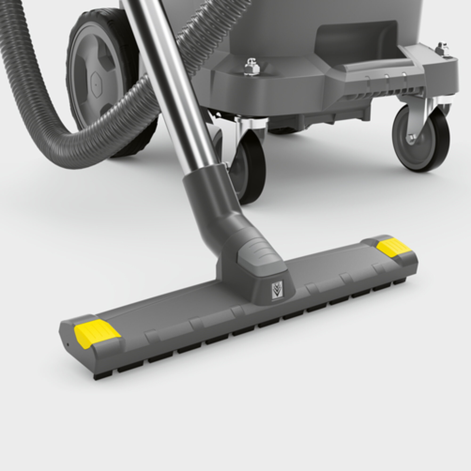 Vacuum cleaner head and wheels. Grey and black with yellow accents. White background.