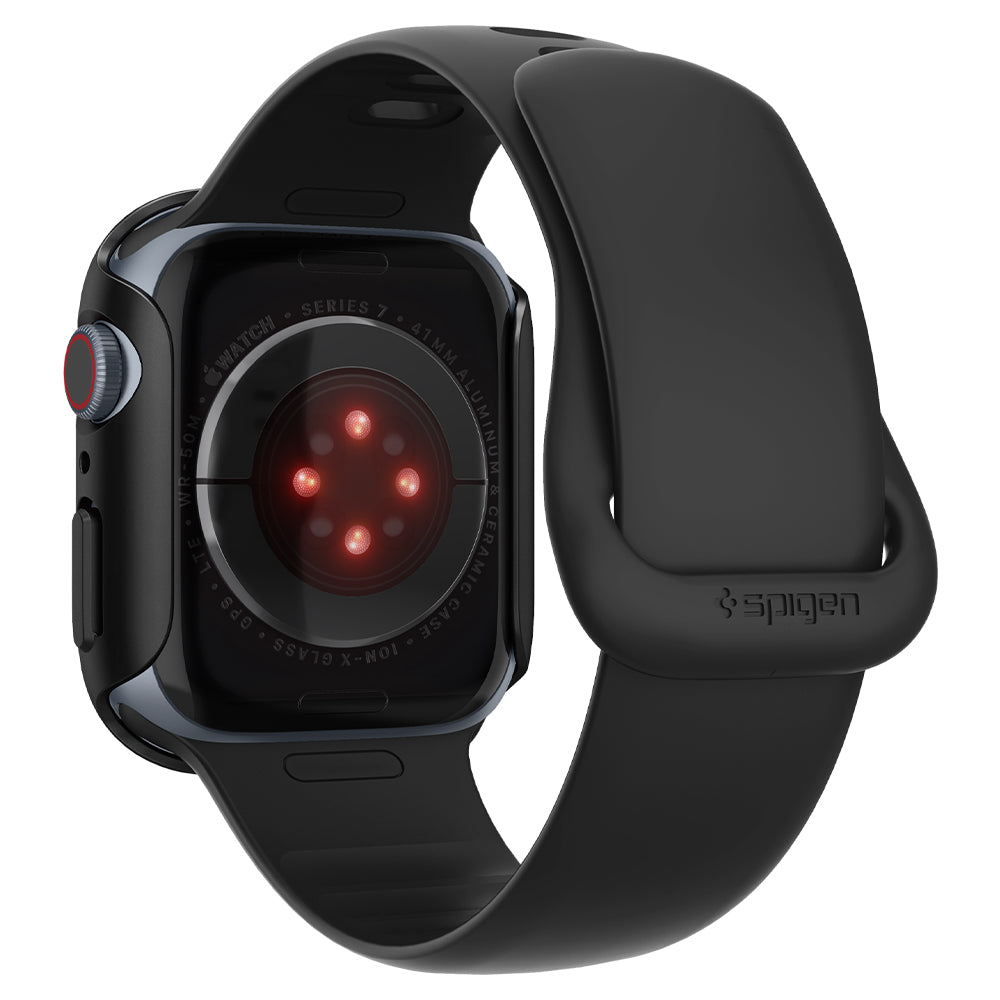 Black Apple watch with a black band. The back shows red sensors and the watch details.
