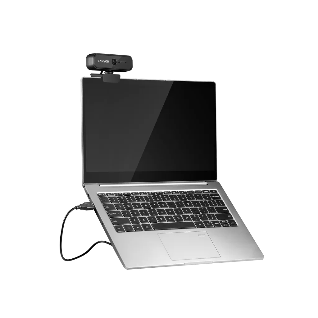 Laptop z kamerą internetową na górze. Laptop jest srebrny i ma klawiaturę i ekran.