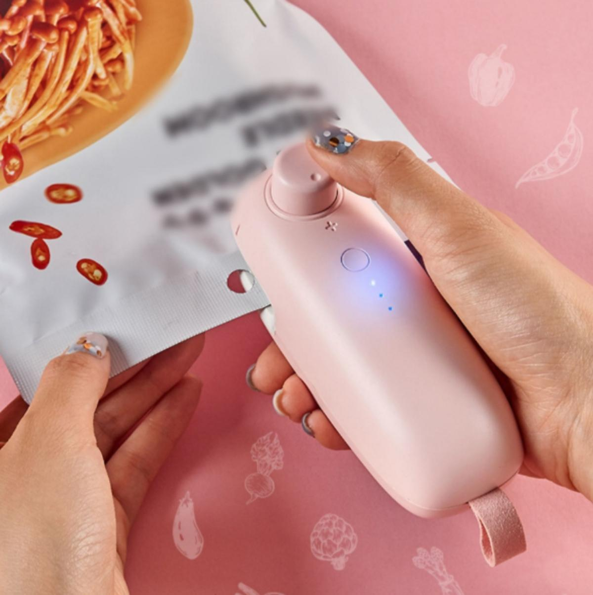 Eine Person versiegelt einen Beutel mit einem rosa Versiegler. Der Beutel ist weiß mit Text.