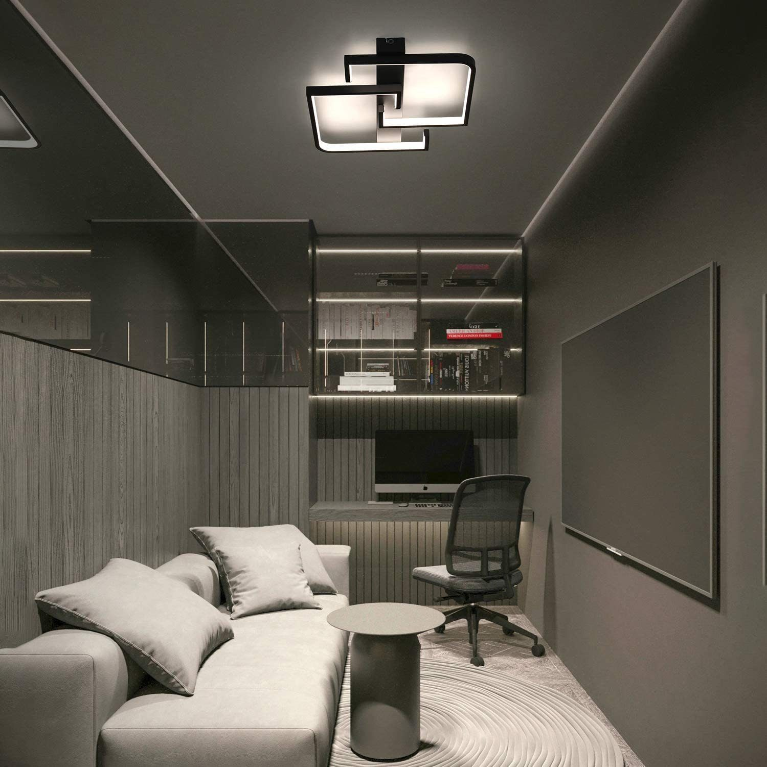 Stanza moderna con lampada da soffitto, divano e zona scrivania, in tema grigio scuro.