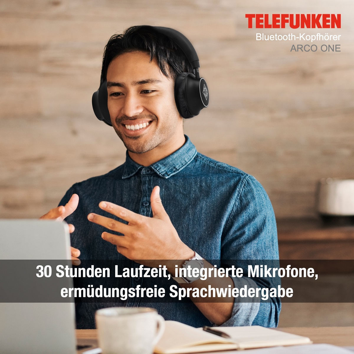 Mann mit Kopfhörern lächelt, nutzt Laptop. Text: 30h Akku, integrierte Mikrofone, ermüdungsfreie Stimme.