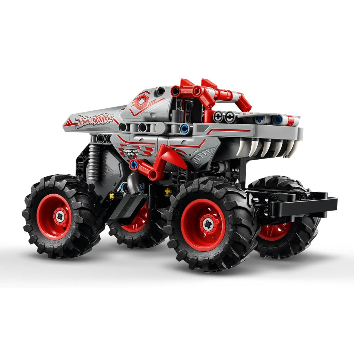 Gri ve kırmızı bir Lego canavar kamyonu. Kamyonun büyük tekerlekleri ve köpekbalığı benzeri bir tasarımı var.