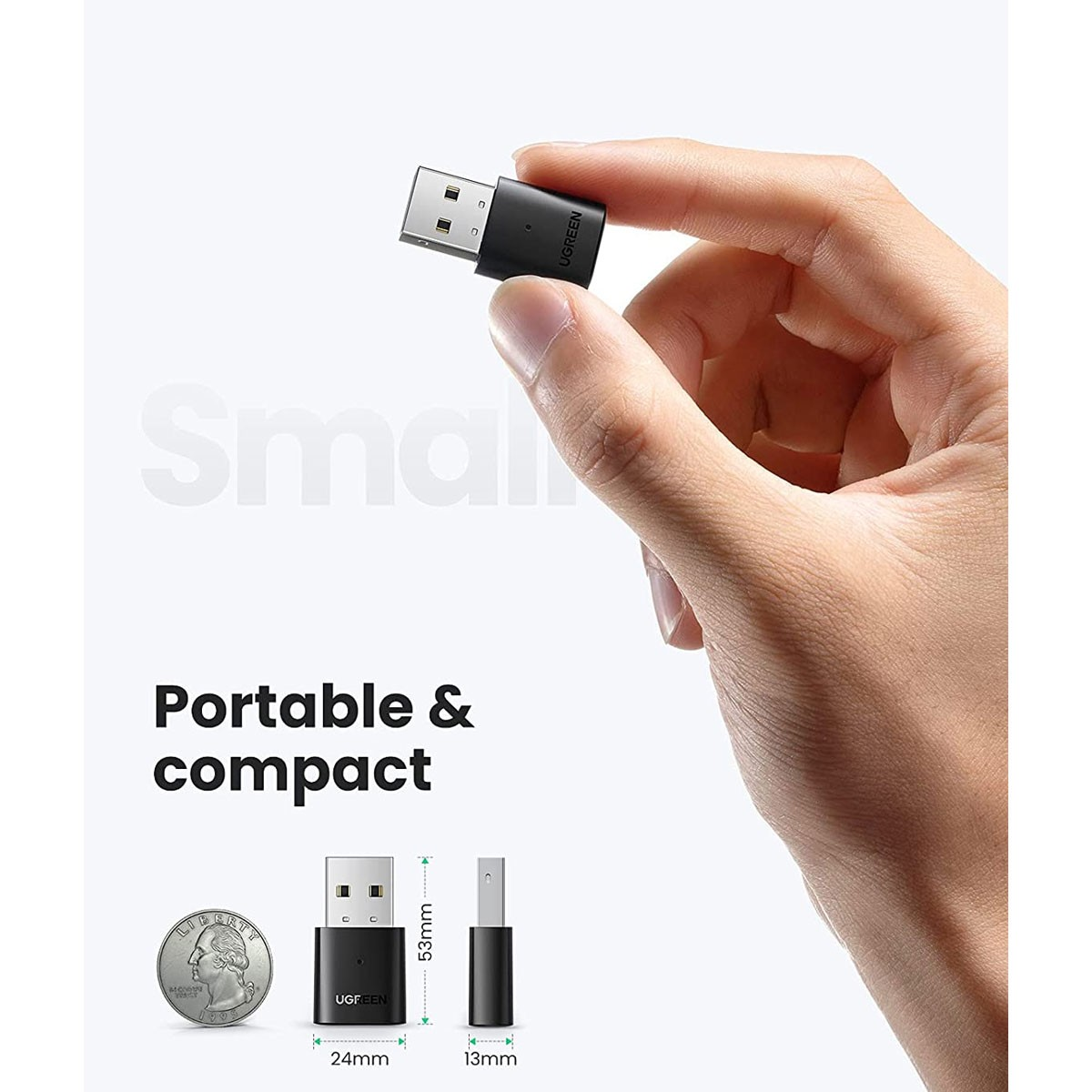 Mały, czarny adapter USB trzymany w dłoni. Adapter ma napis UGREEN.