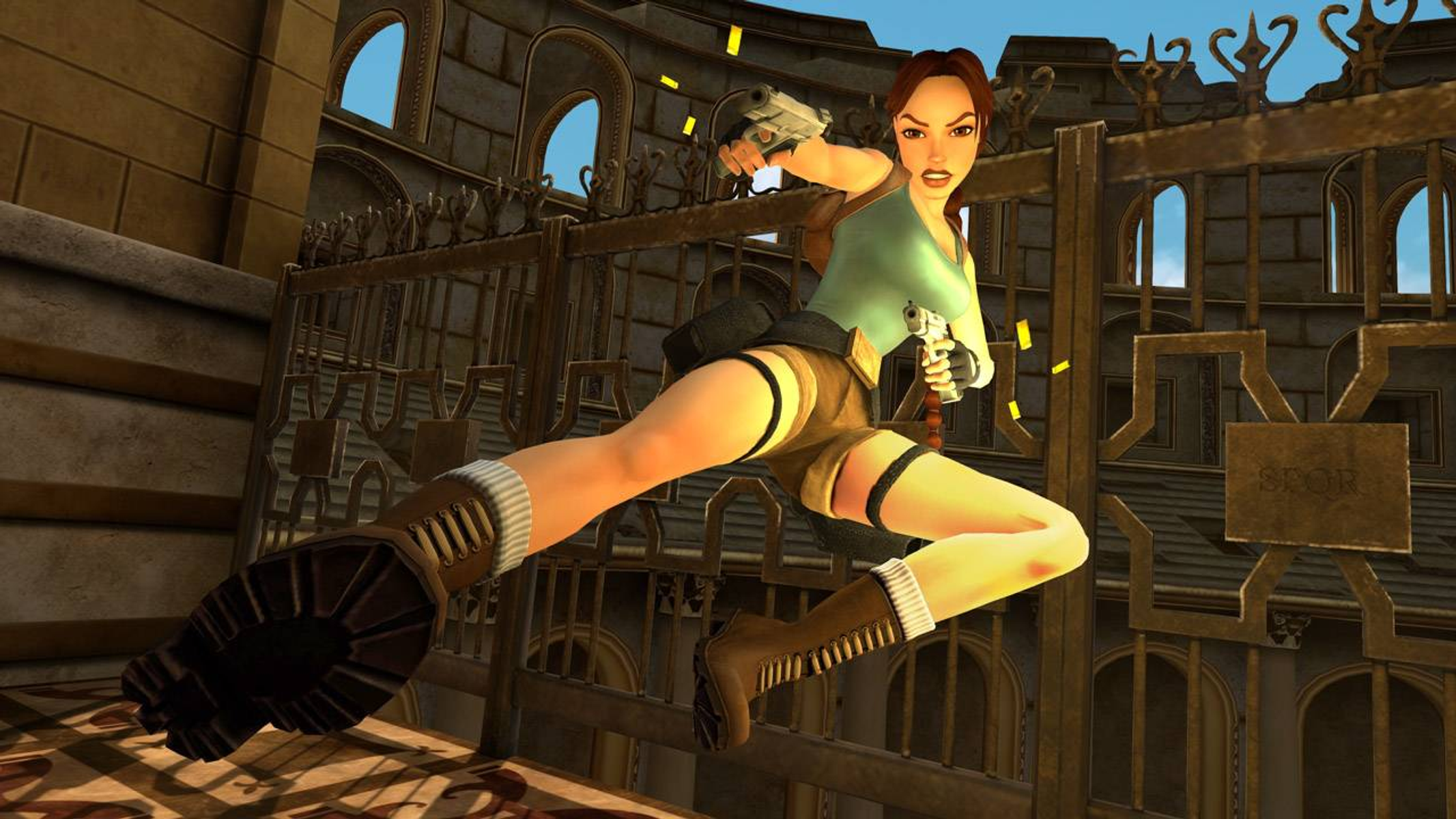 Lara Croft en acción, saltando con armas en un entorno similar a un templo.