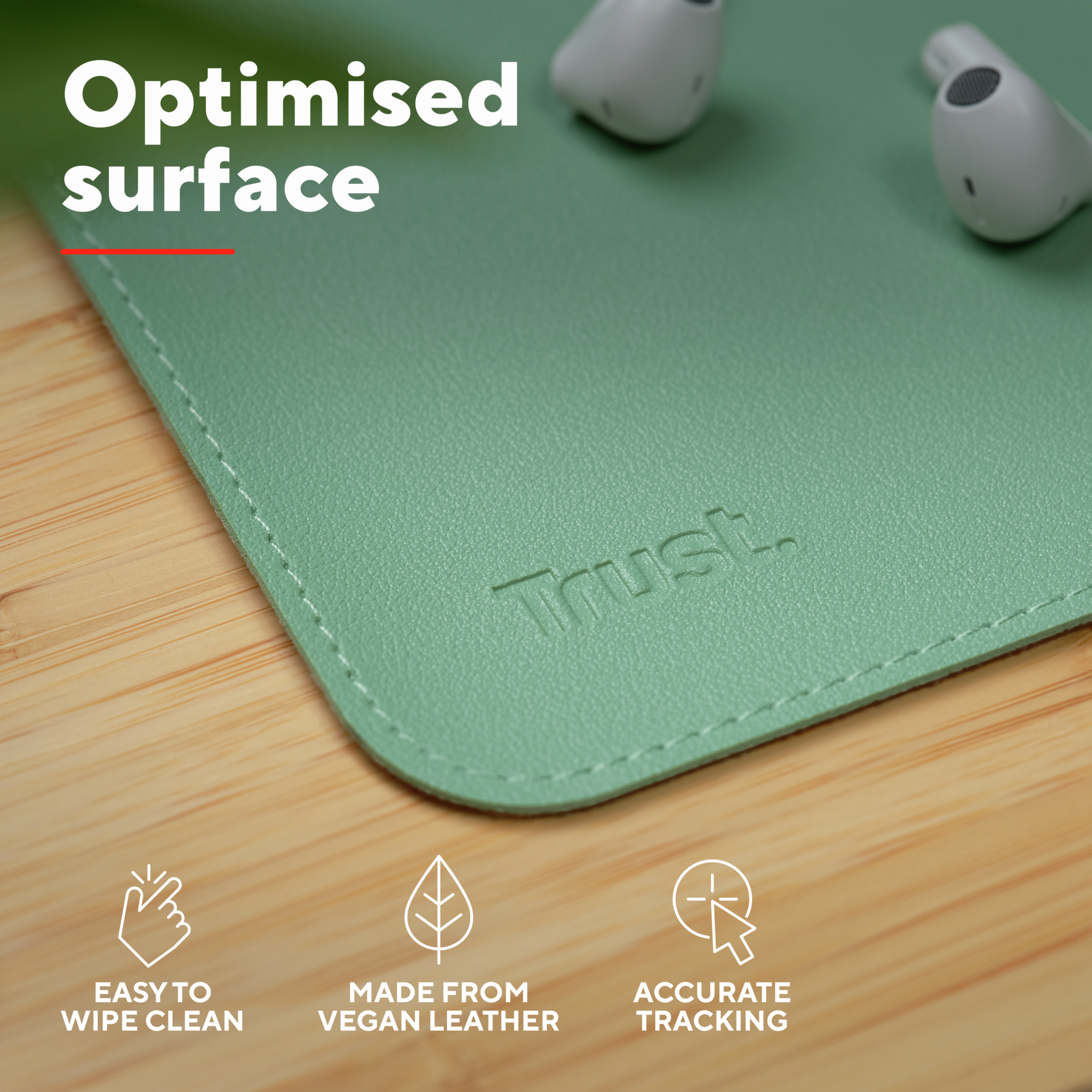 Close up of desk pad with the brand Trust. and text: easy to wipe clean, made from vegan leather, accurate tracking.
