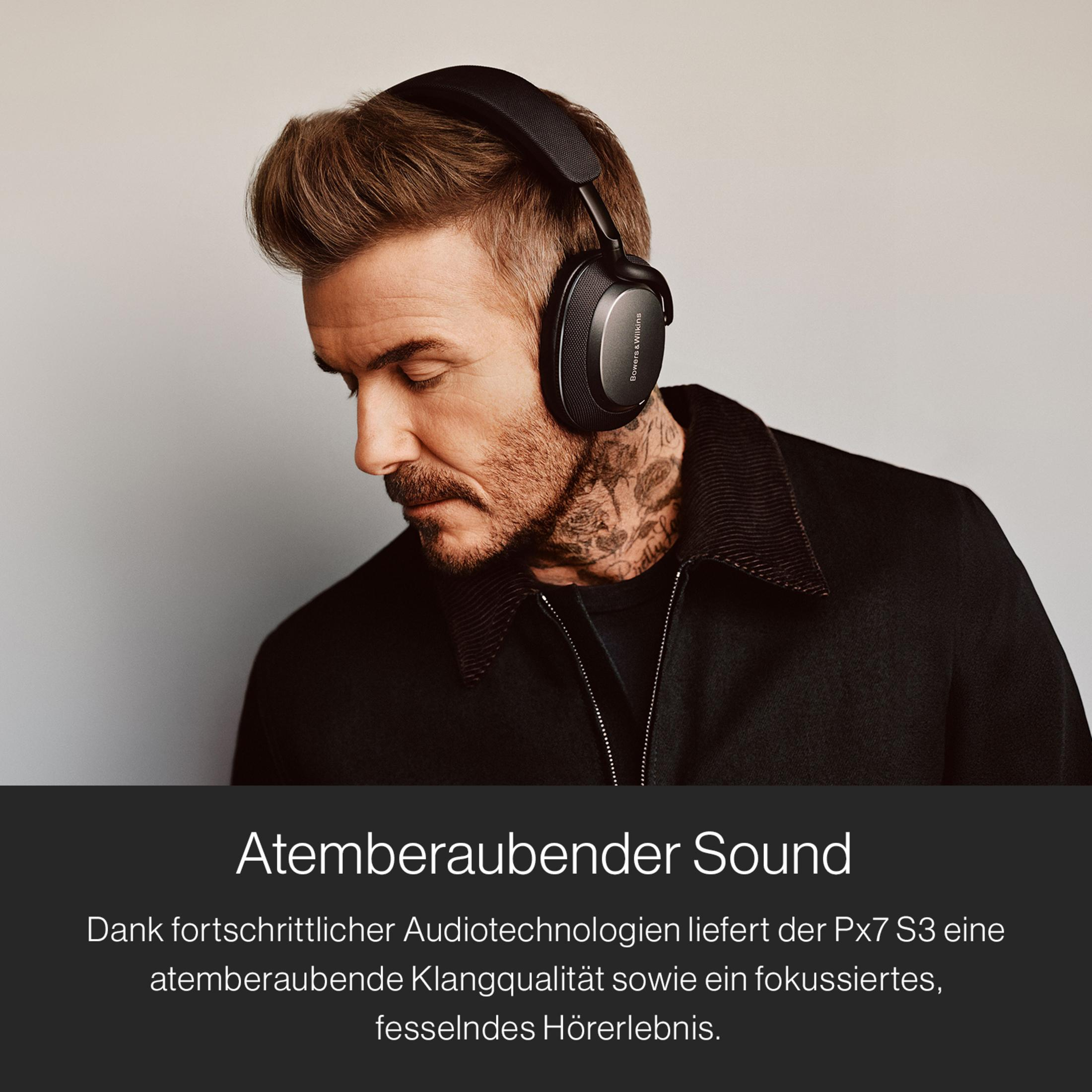 Mężczyzna w czarnych słuchawkach, spogląda w dół. Tekst: 'Atemberaubender Sound'.