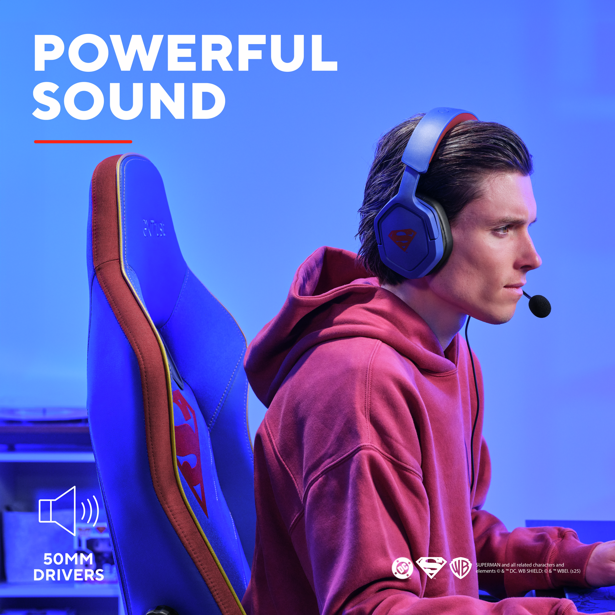 Mann benutzt blaues Headset mit rotem Superman-Logo. Blauer und roter Stuhl, Hintergrund.