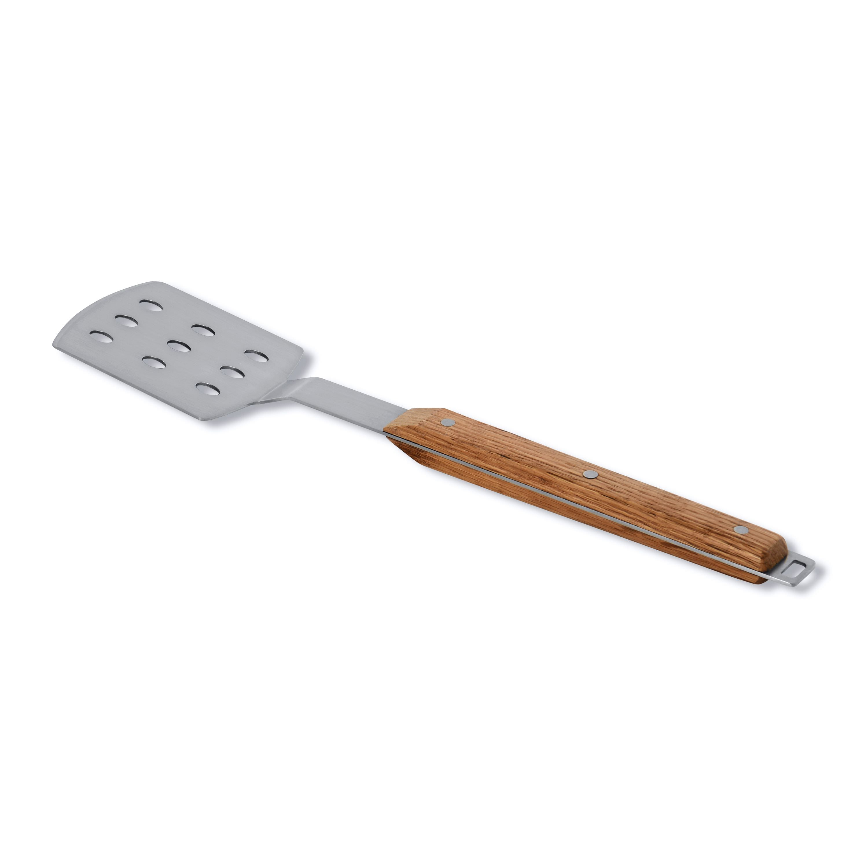 A silver spatula with a wooden handle. It has holes on the top. It is on a white background.