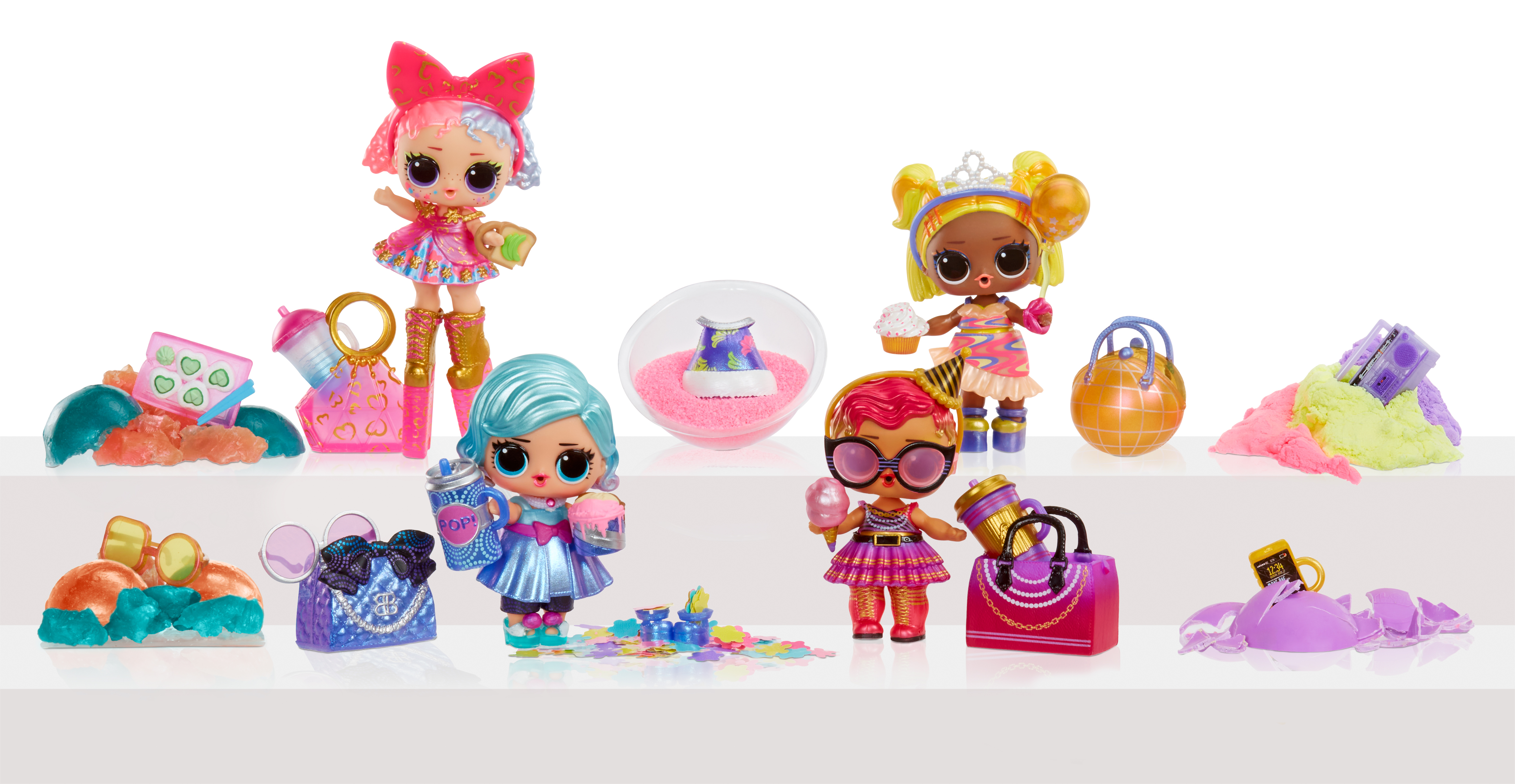 Wiele lalek z akcesoriami na białej powierzchni.